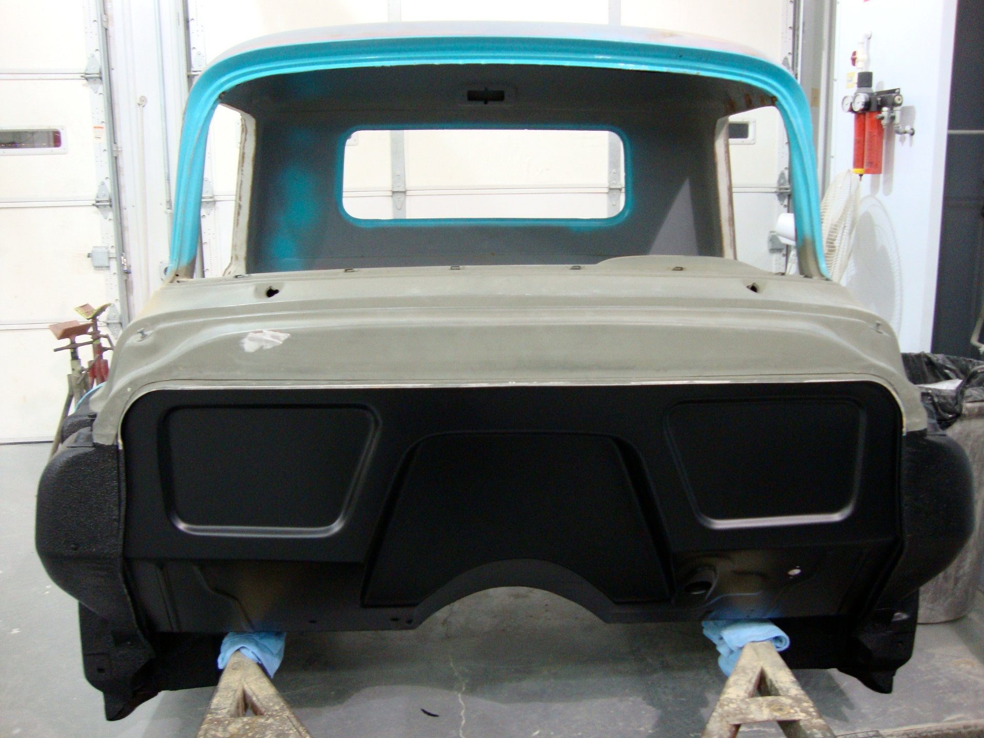 The same firewall later finished in satin black — the color and finish would carry through the build.