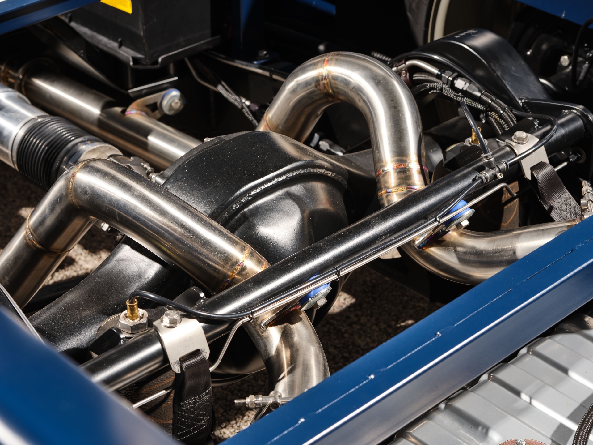 Close-up of the exhaust routing between the frame rails.