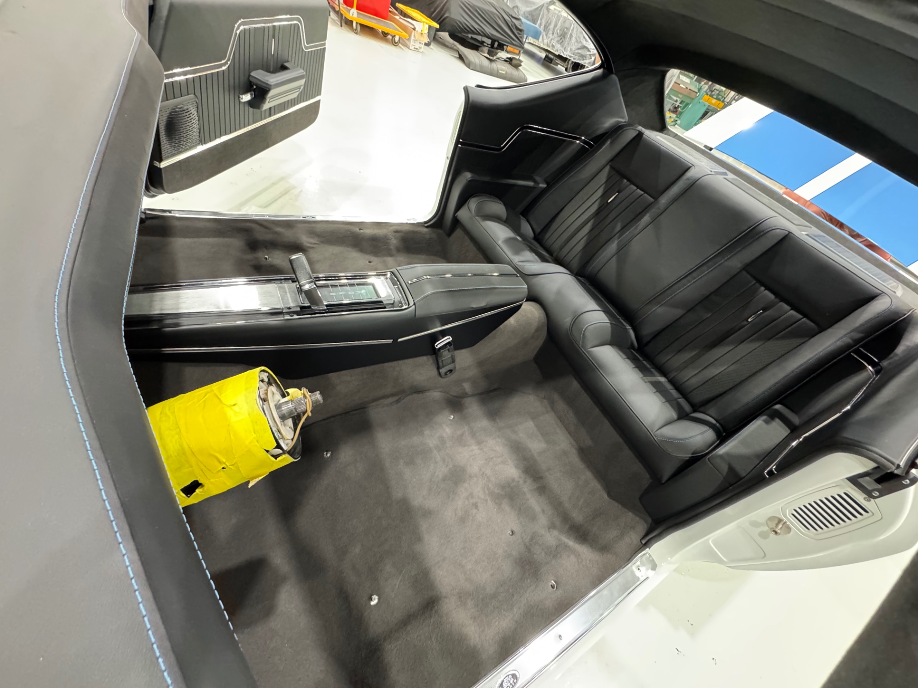 Interior installed — rear seat, console, and door panels finished at Avant Garde Design, Palm City, FL (Oct 2025).