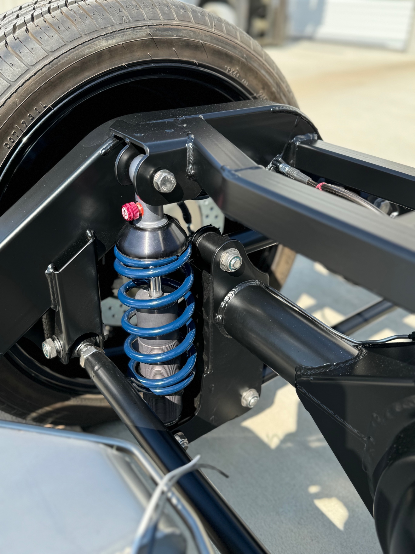 Rear coilover and 4-bar mounting detail.