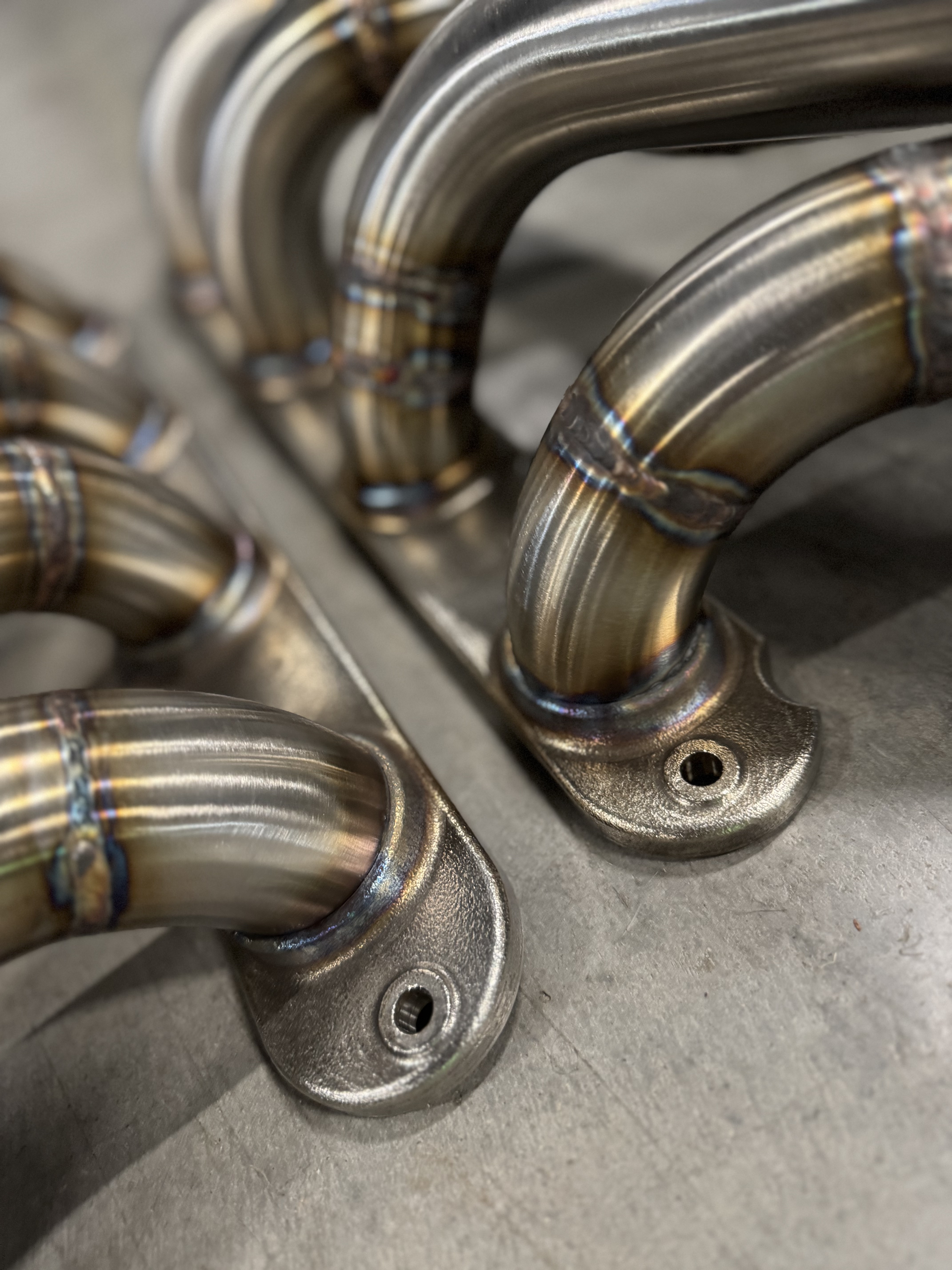 TIG welds and billet stainless collector work up close.