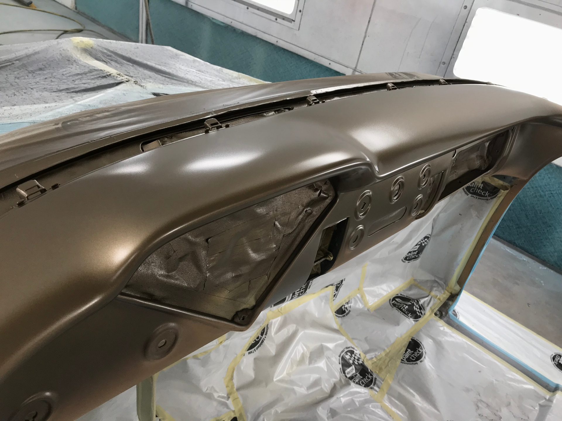 Satin brown metallic finish laid down on the dash top.