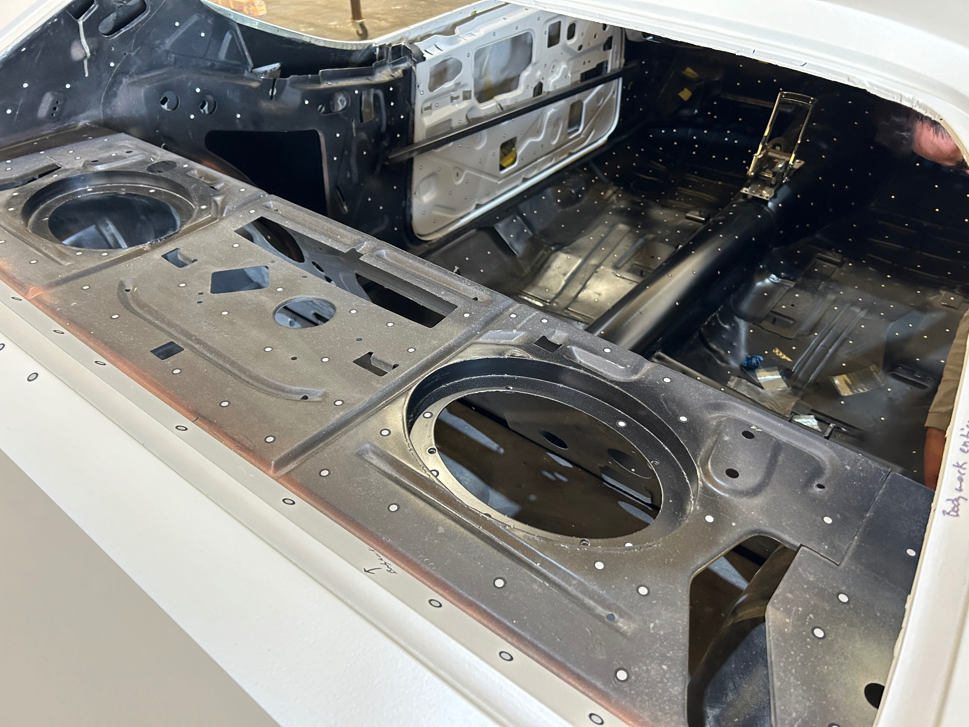 Bare metal shell prepped and coated — scan target dots applied across every inner panel.