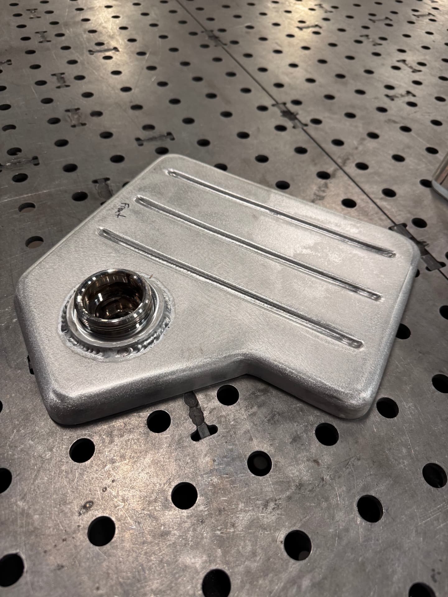 Beaded top panel with the machined filler neck welded in.
