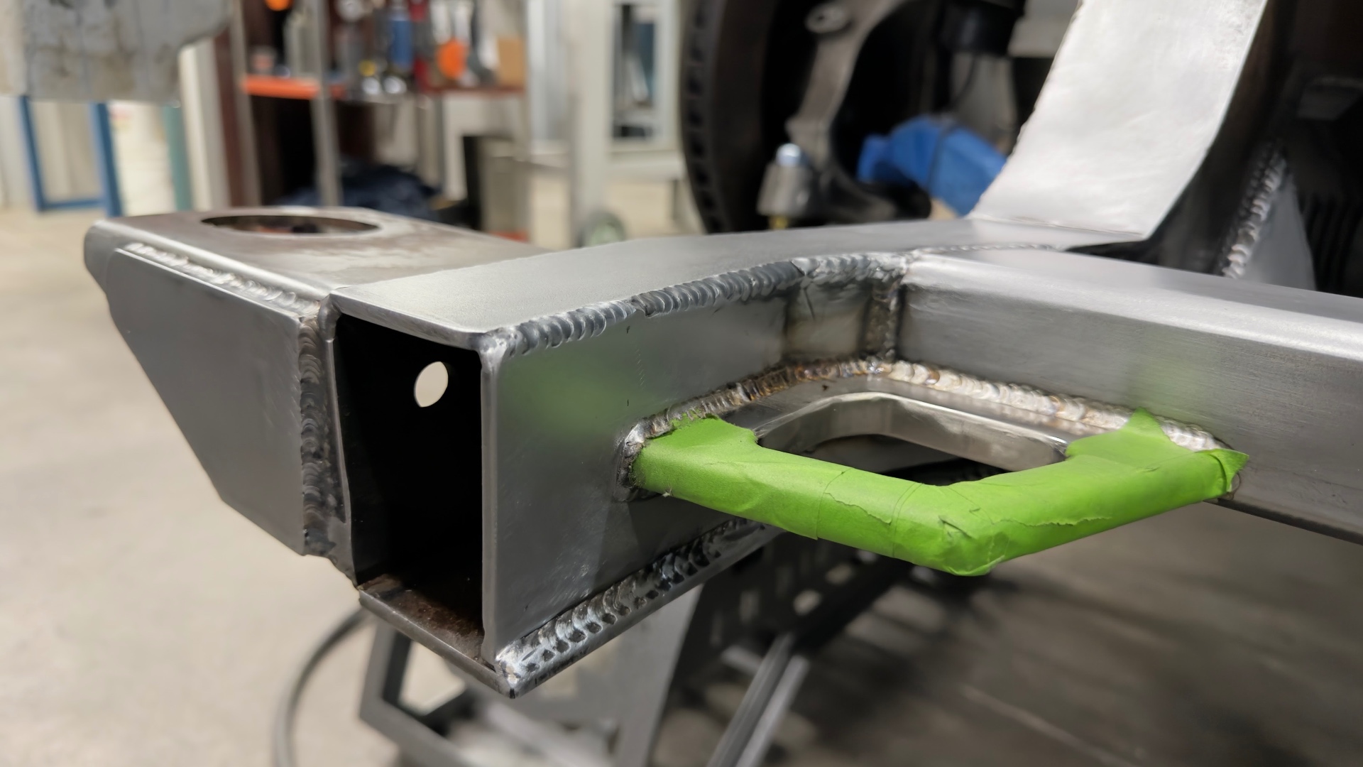 Custom chassis crossmember and suspension mount fabricated in-house.