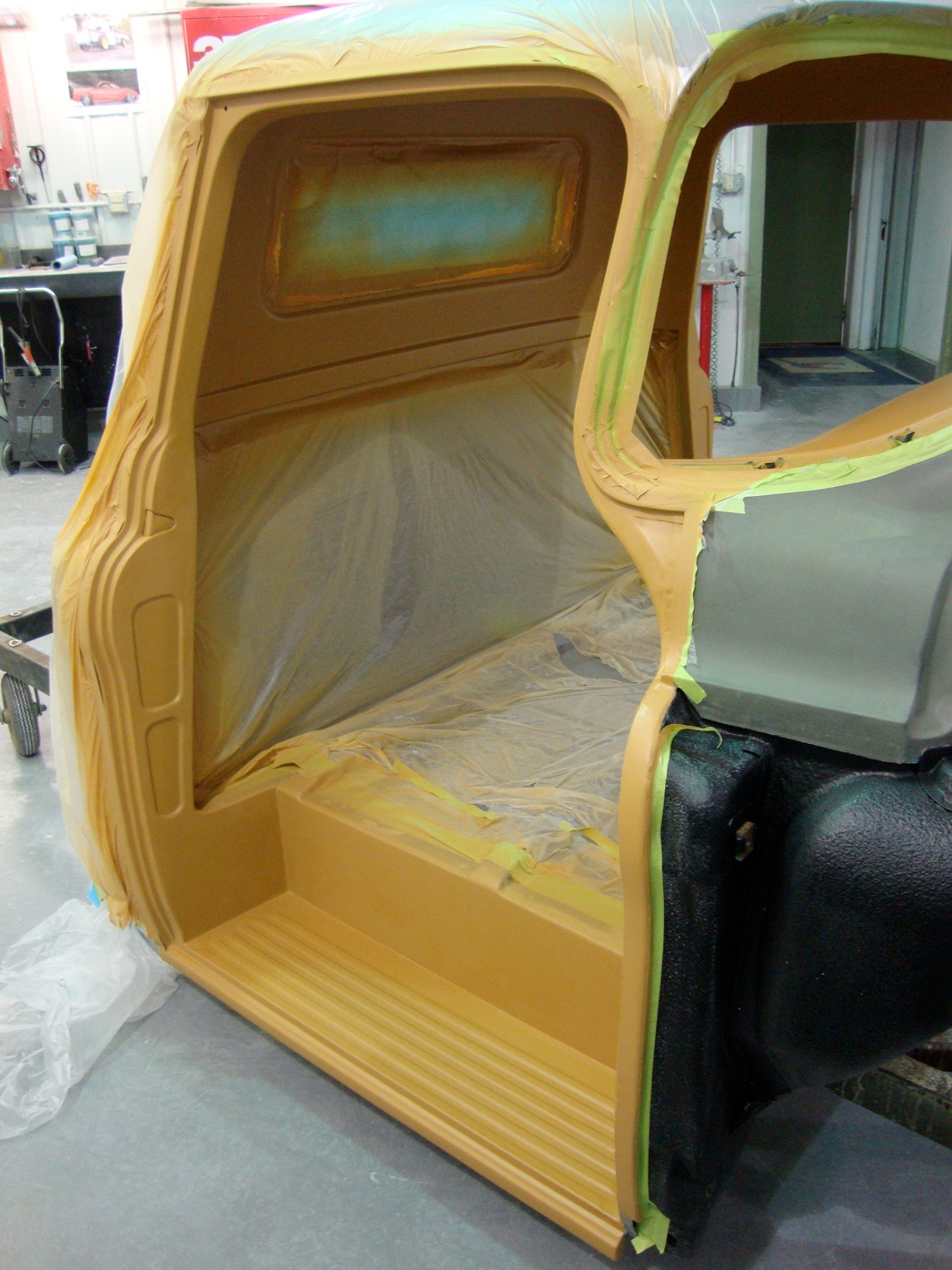 Cab interior in high-build primer — back panel and floor ready to sand.