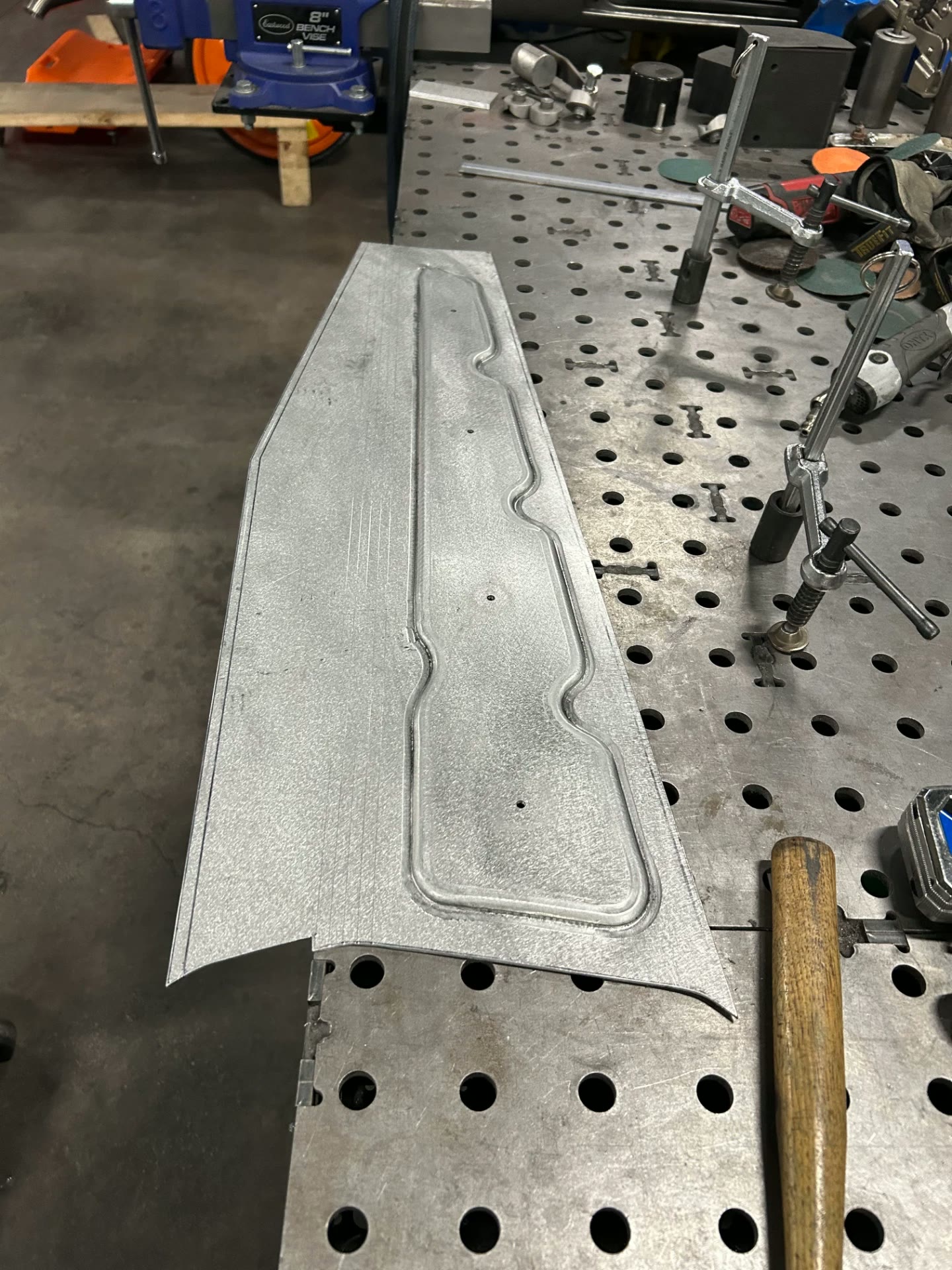 Formed aluminum hood latch panel after running the bead in the Pullmax.