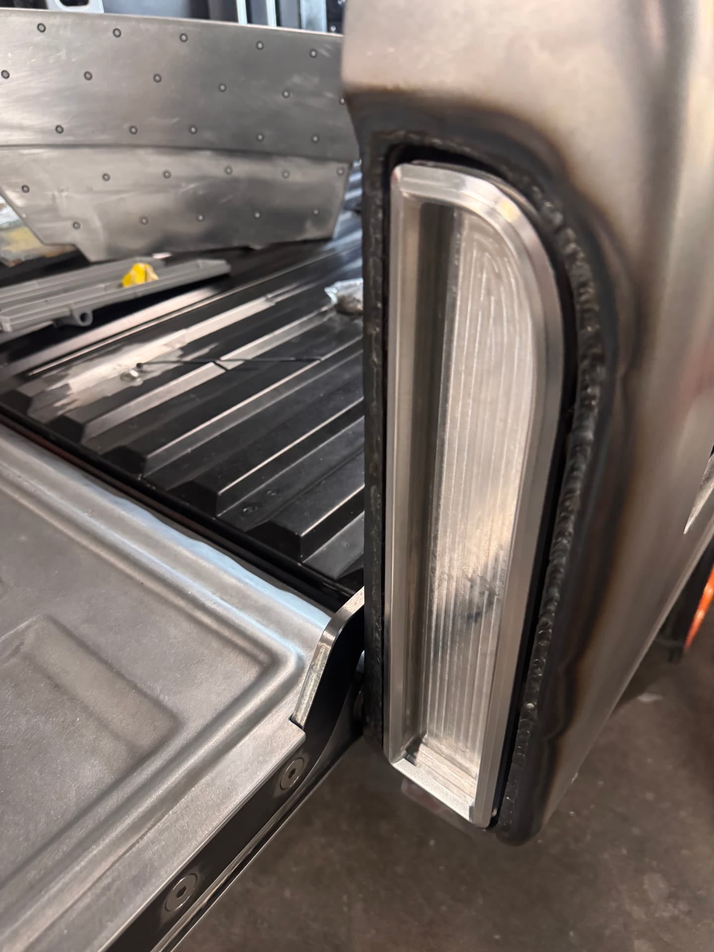 Tail light housing set into the quarter with the fuel filler door hidden behind it.