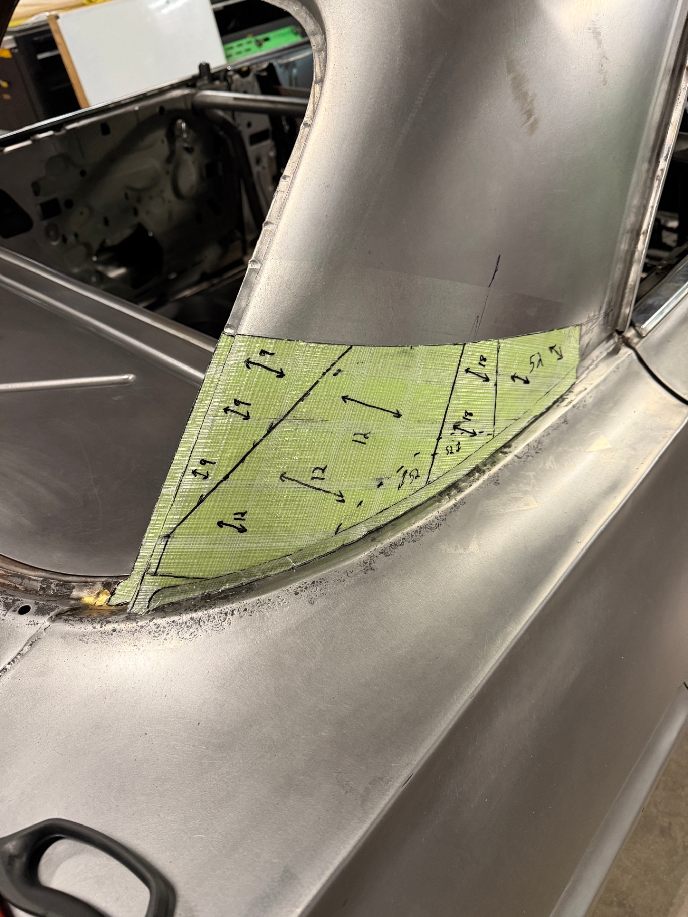 Green fiberglass template taped over the quarter to map the patch panel.