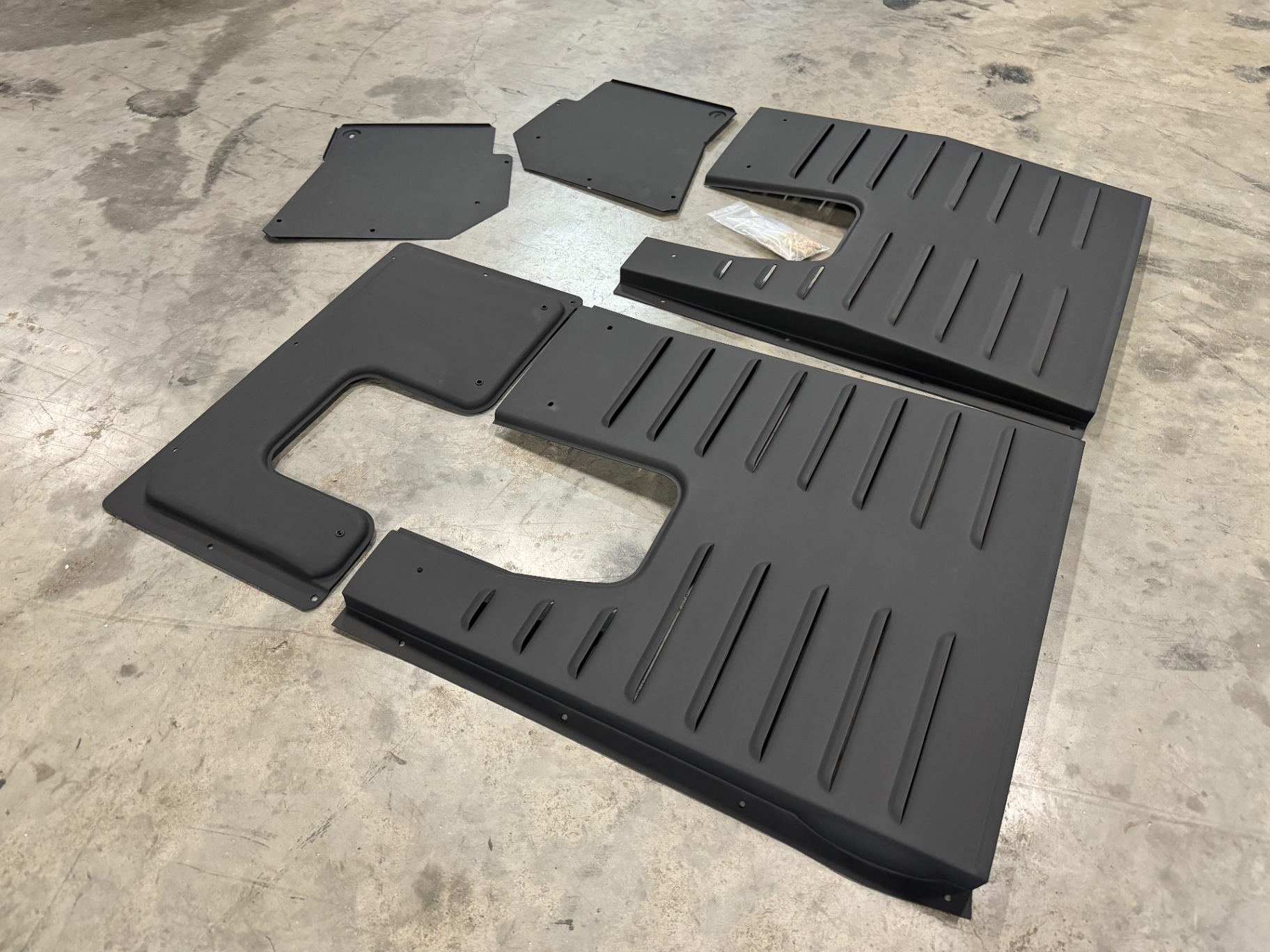 A full set laid out on the shop floor — main pans plus fillers.