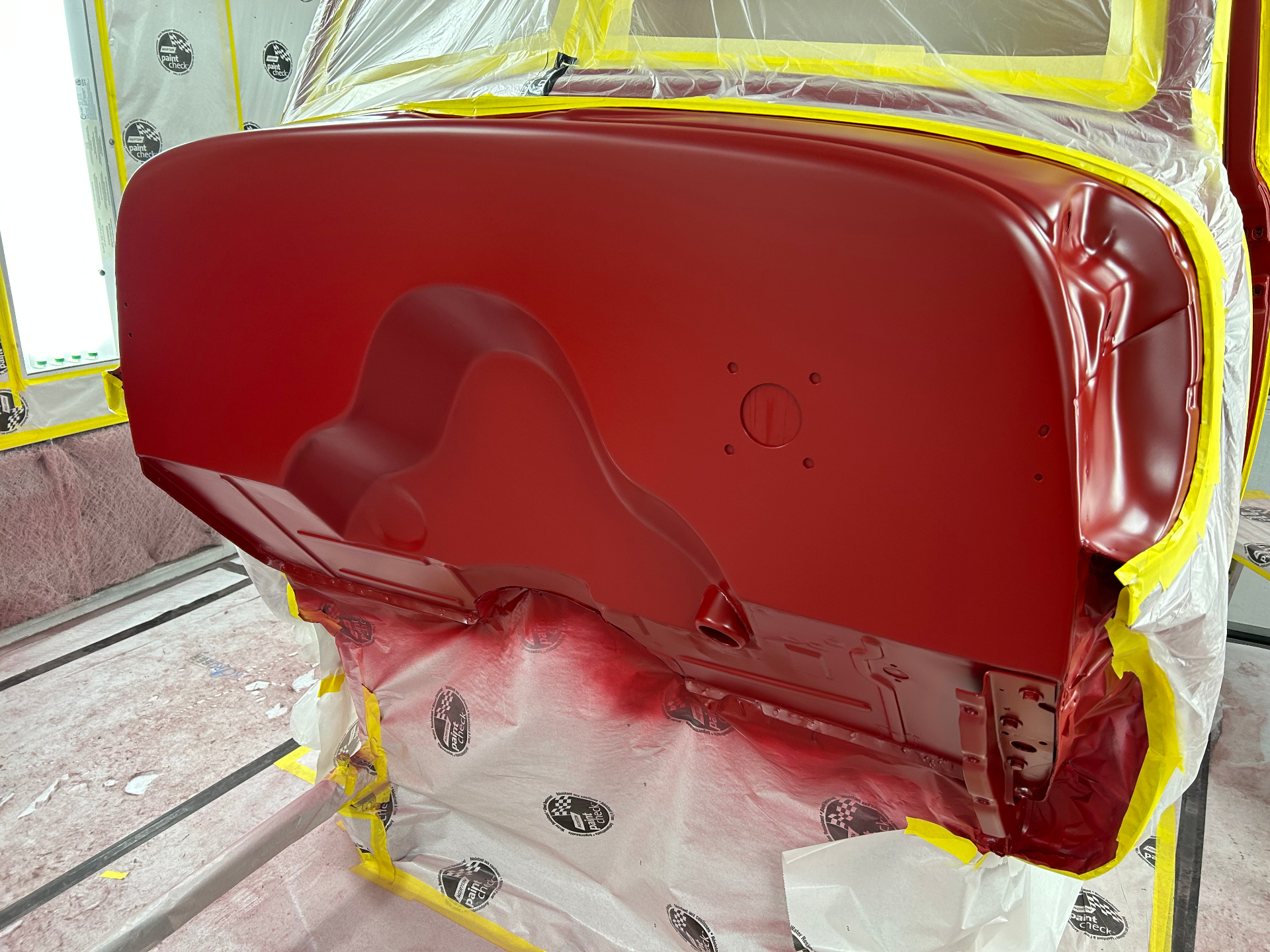 Firewall side of the cab — sprayed body color so under-hood is as finished as the outside.