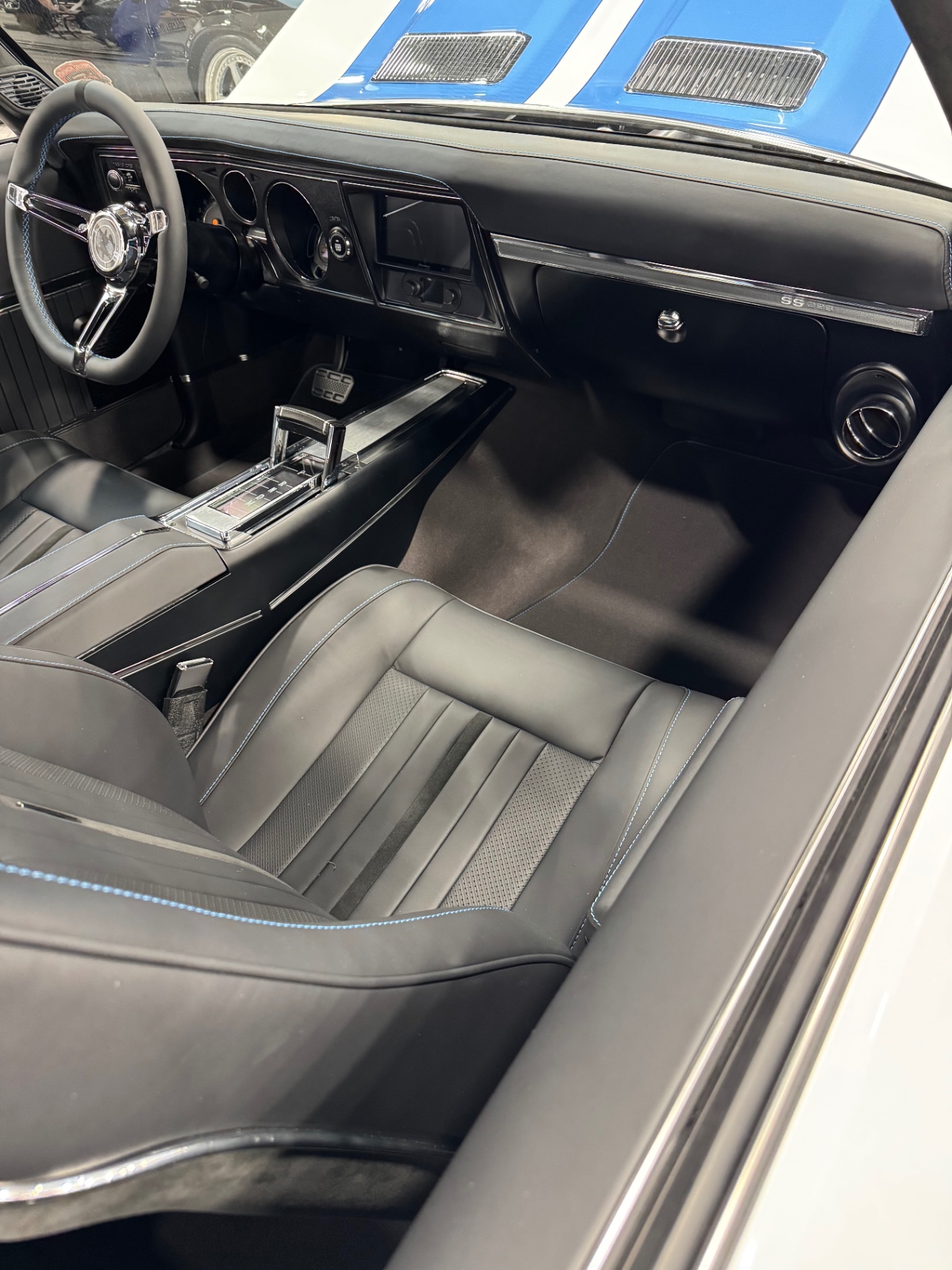Interior on the show floor — front buckets, console, and SS dash.
