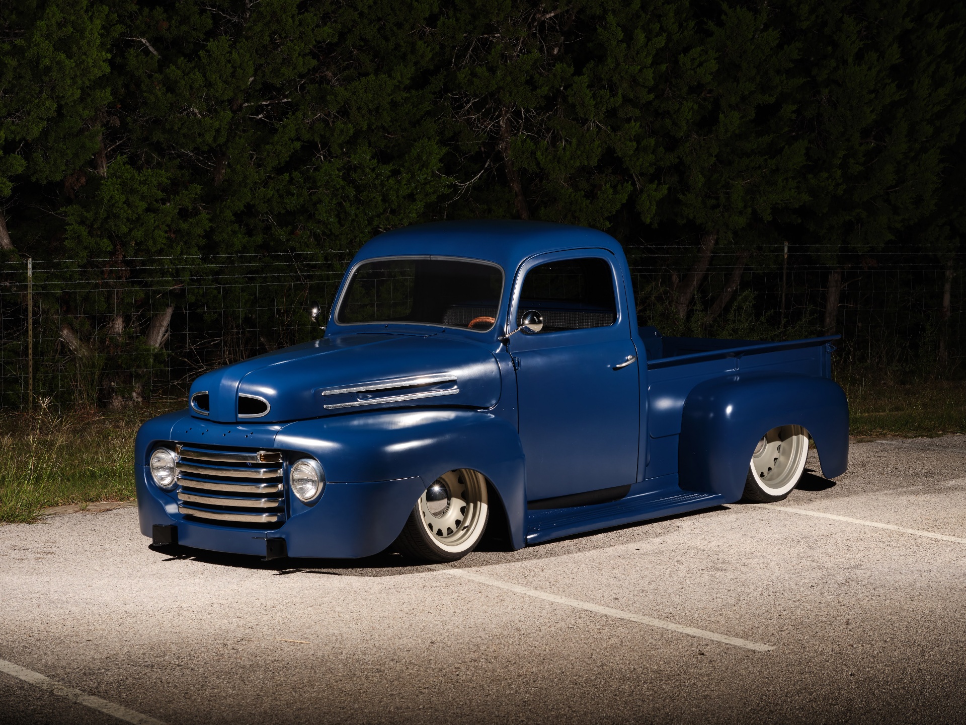 Front three-quarter — original grille and hood spears preserved and polished.