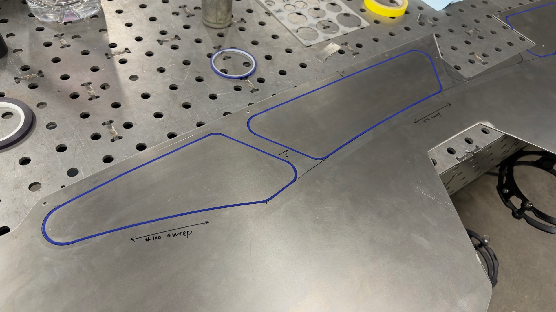 Sweep templates laid out on a raw panel — #100 and #84 sweeps marked before forming.
