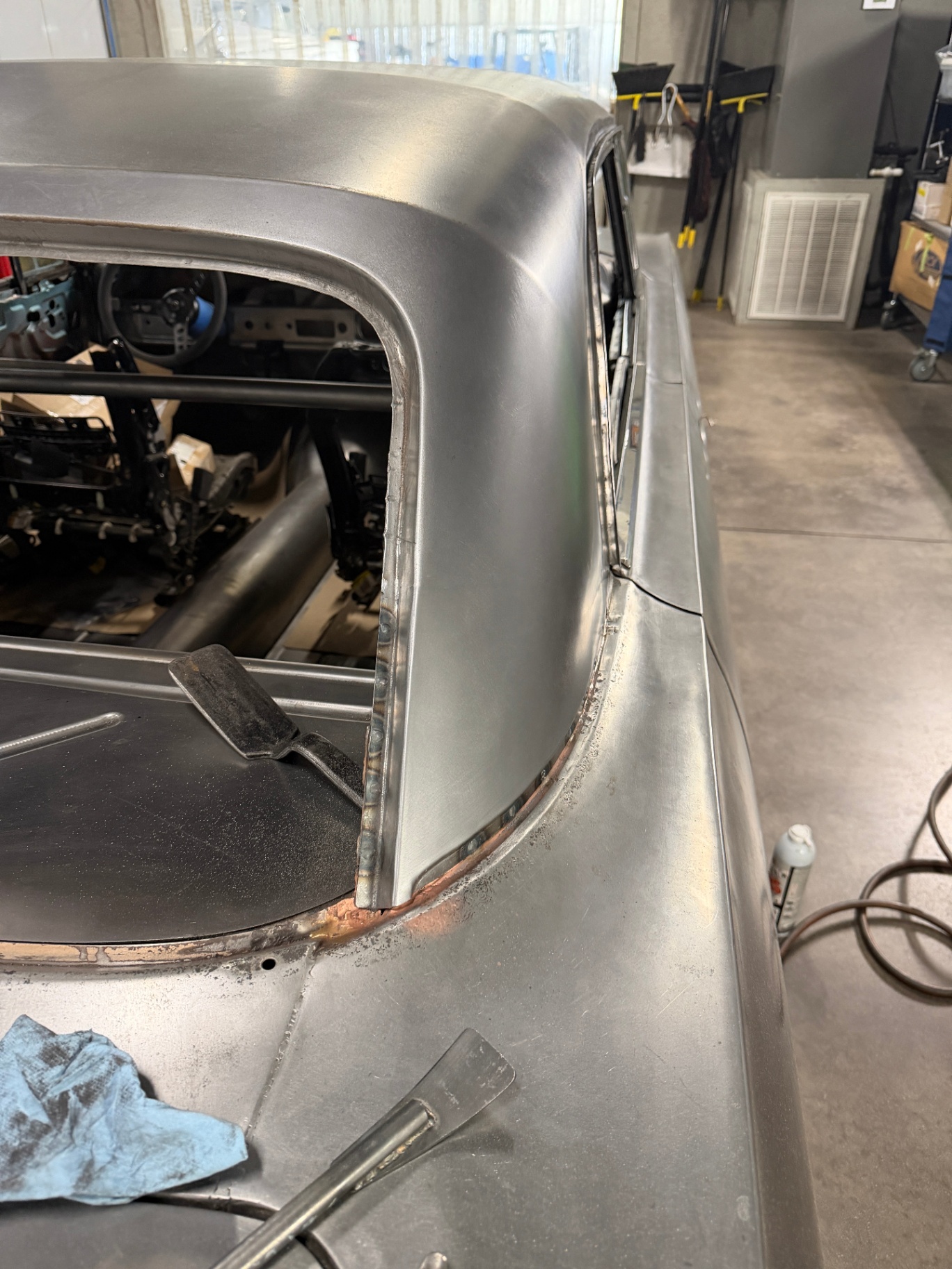 Roof-to-quarter transition around the rear window opening, ready for finish work.