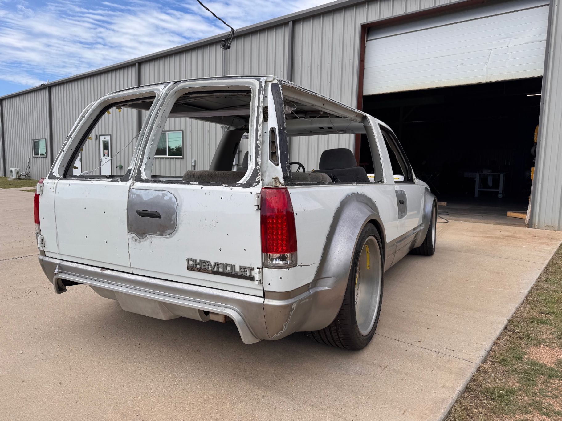 Straight rear — hand-shaped tailgate, bumper, and quarter flares.