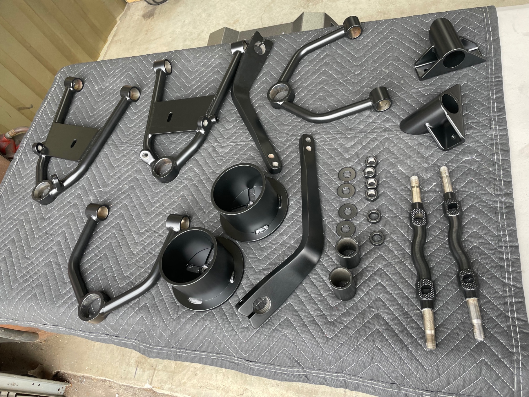 Same parts back from powder — satin black, ready to assemble.