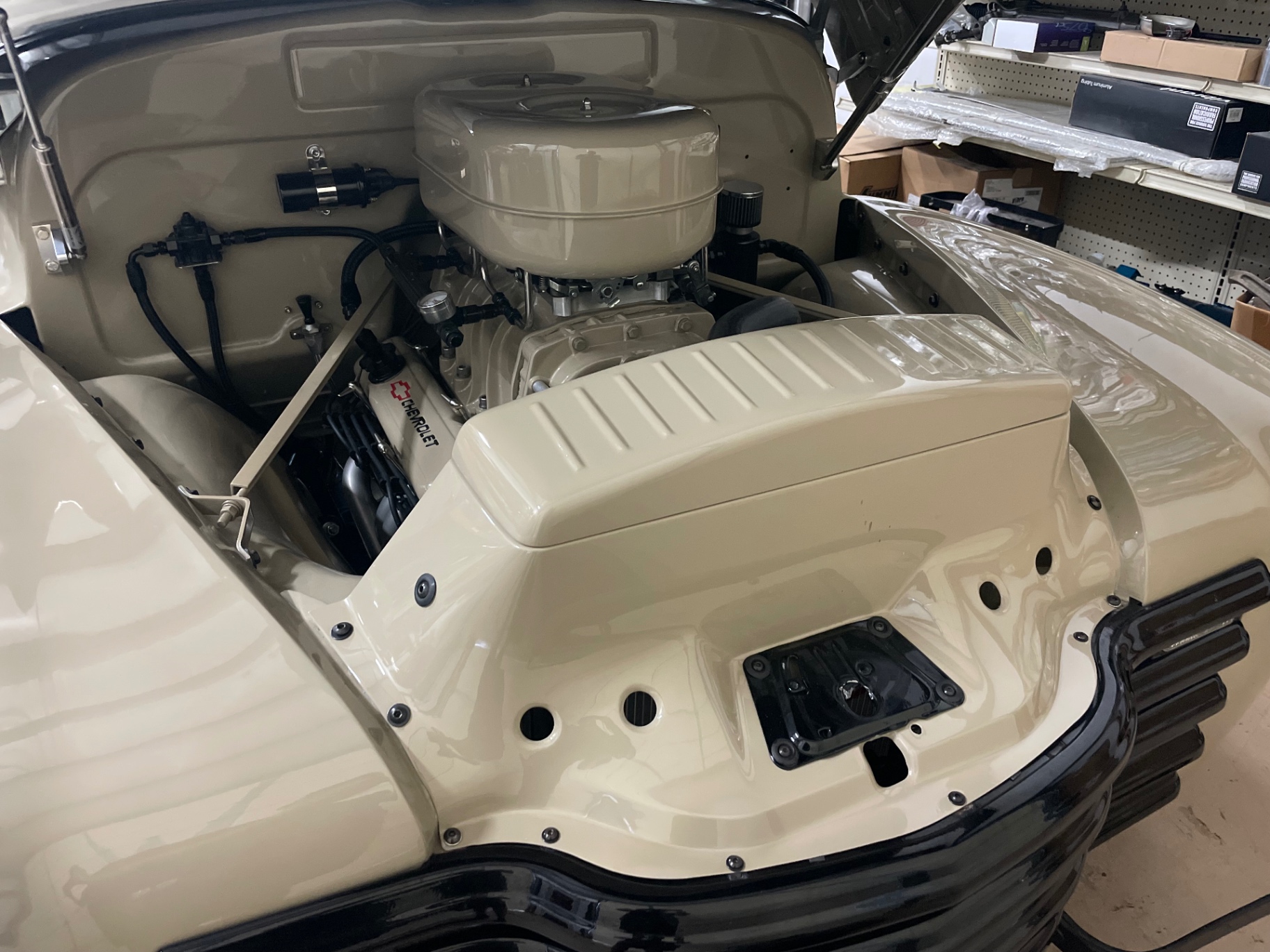 Engine set back in — tan air cleaner and valve covers tie the bay to the body.