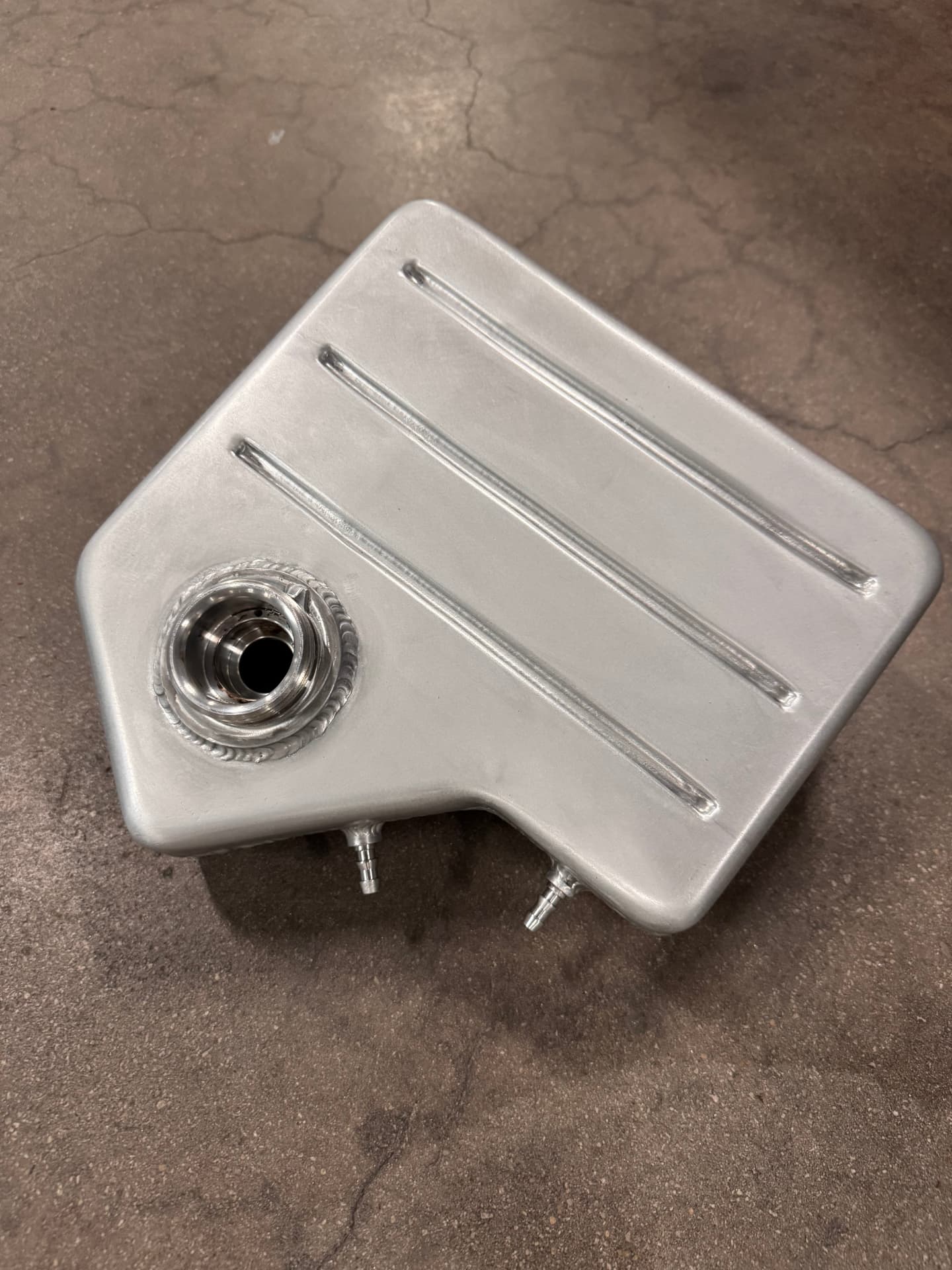 Another angle of the finished tank showing the beaded top and welded fittings.