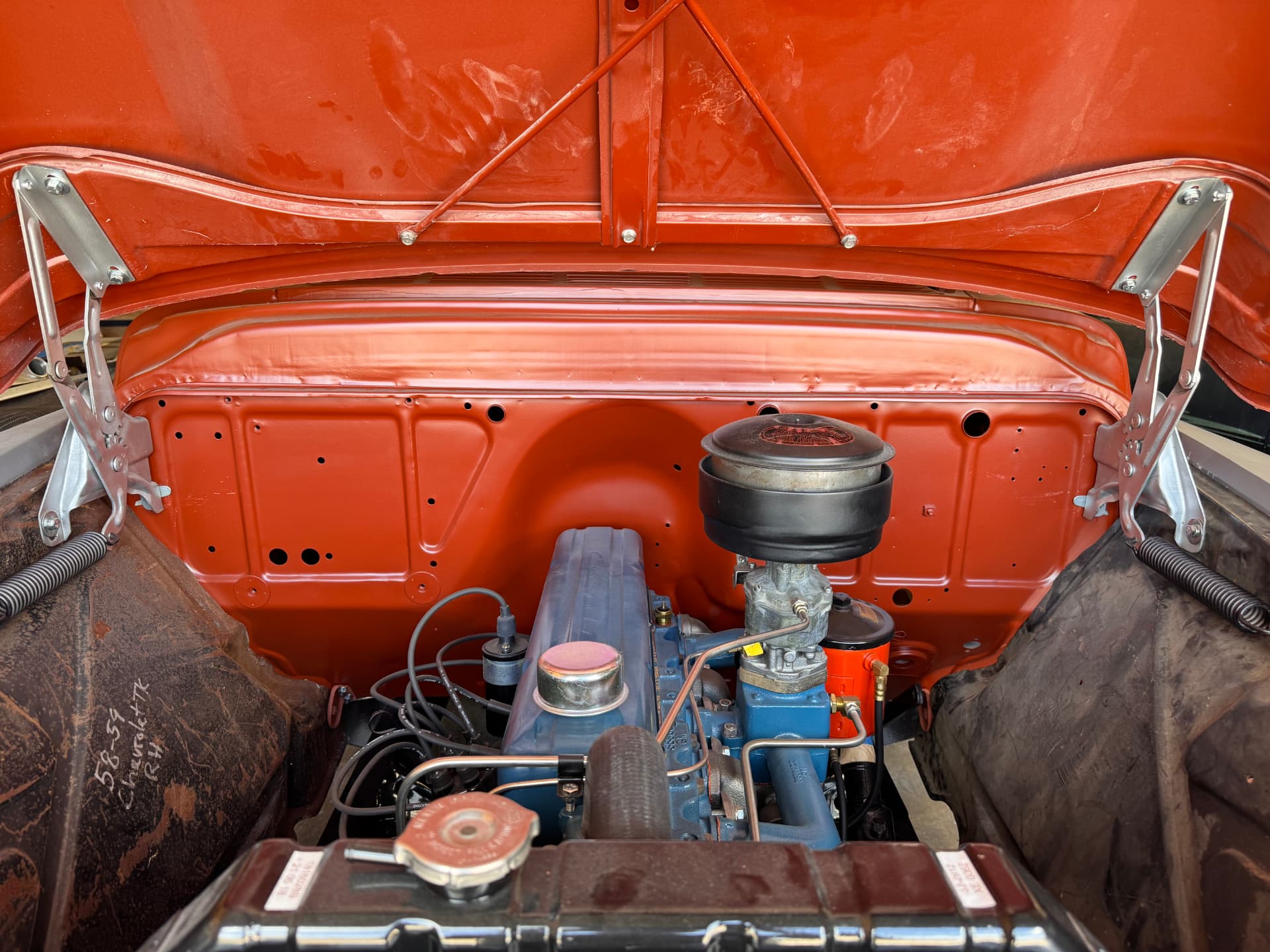 Firewall and engine bay finished in orange with the six in place.