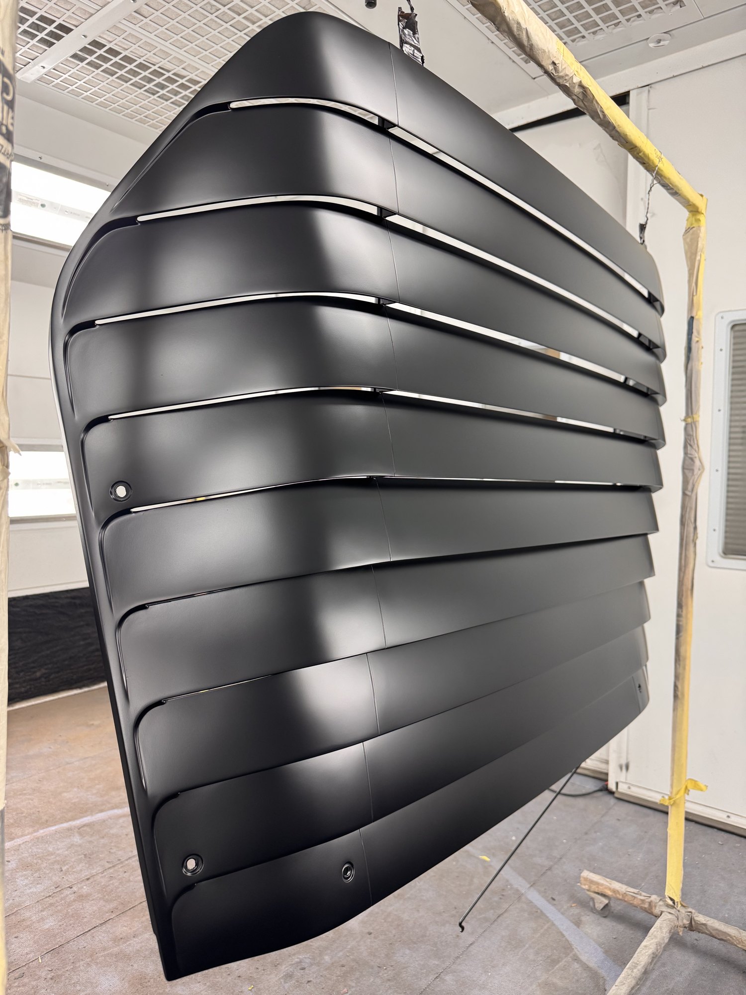 Low angle down the louver stack. No glare, no orange peel — just the shapes.