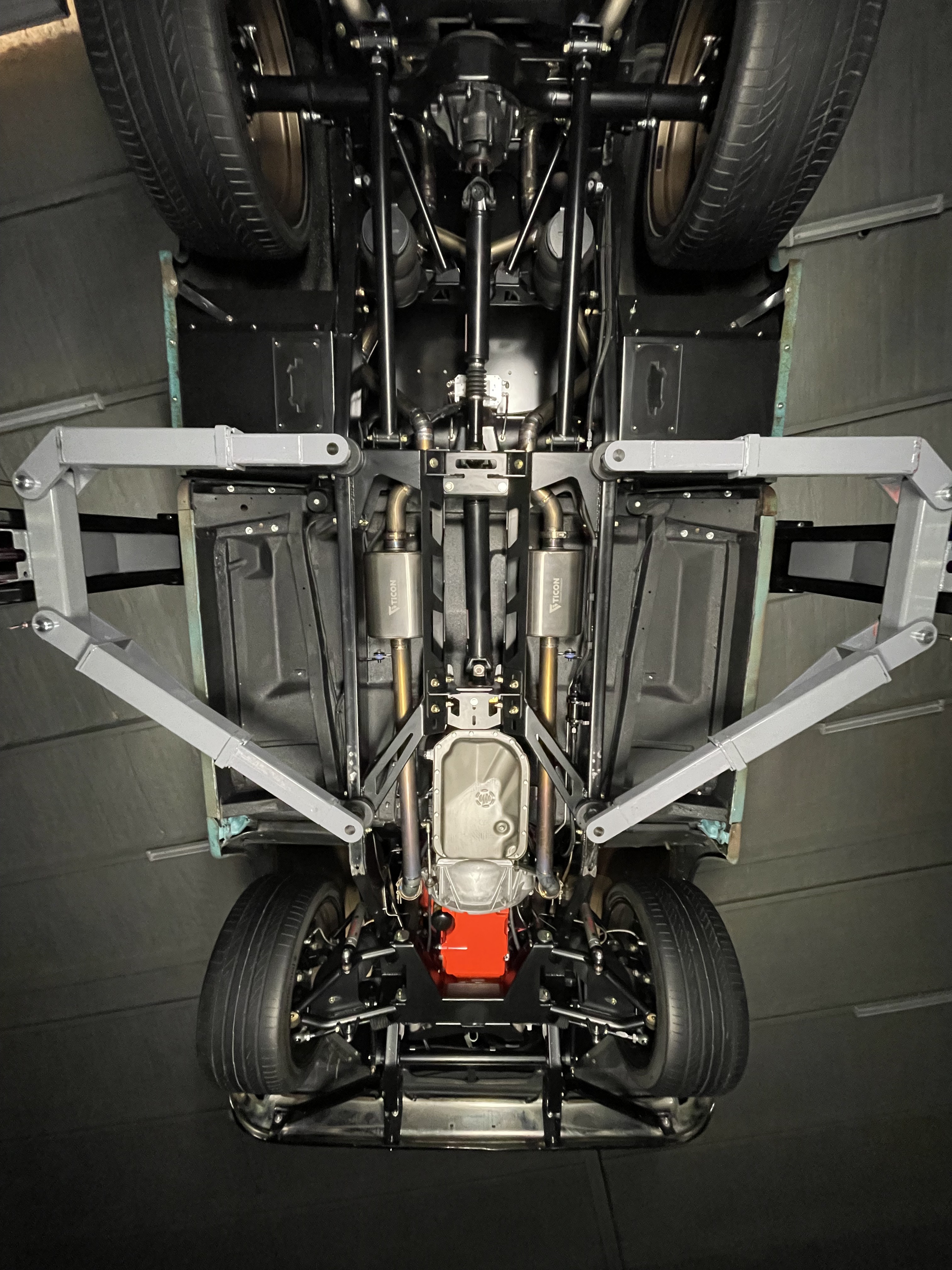 Underside view — clean chassis layout and driveline from front to rear.