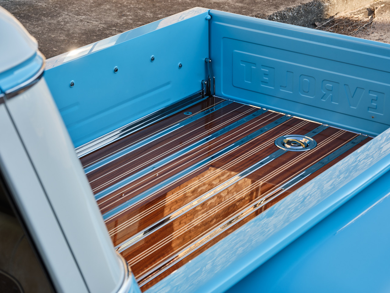 Bed detail — satin clear-coated over the blue, body-color painted bed sides.