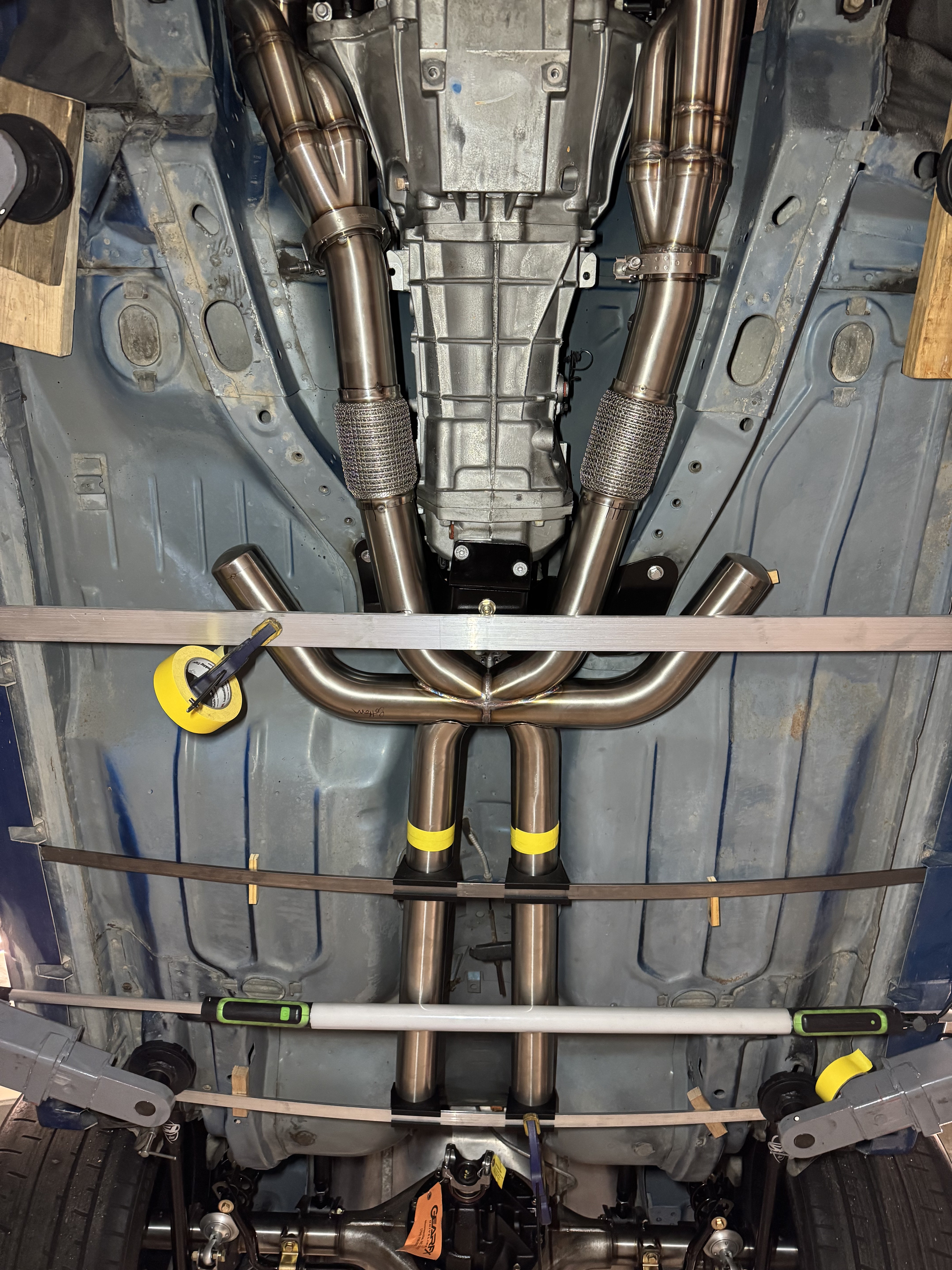 The experimental combined X/H-pipe section and forward-facing resonance tubes being fitted beneath the TR6060.