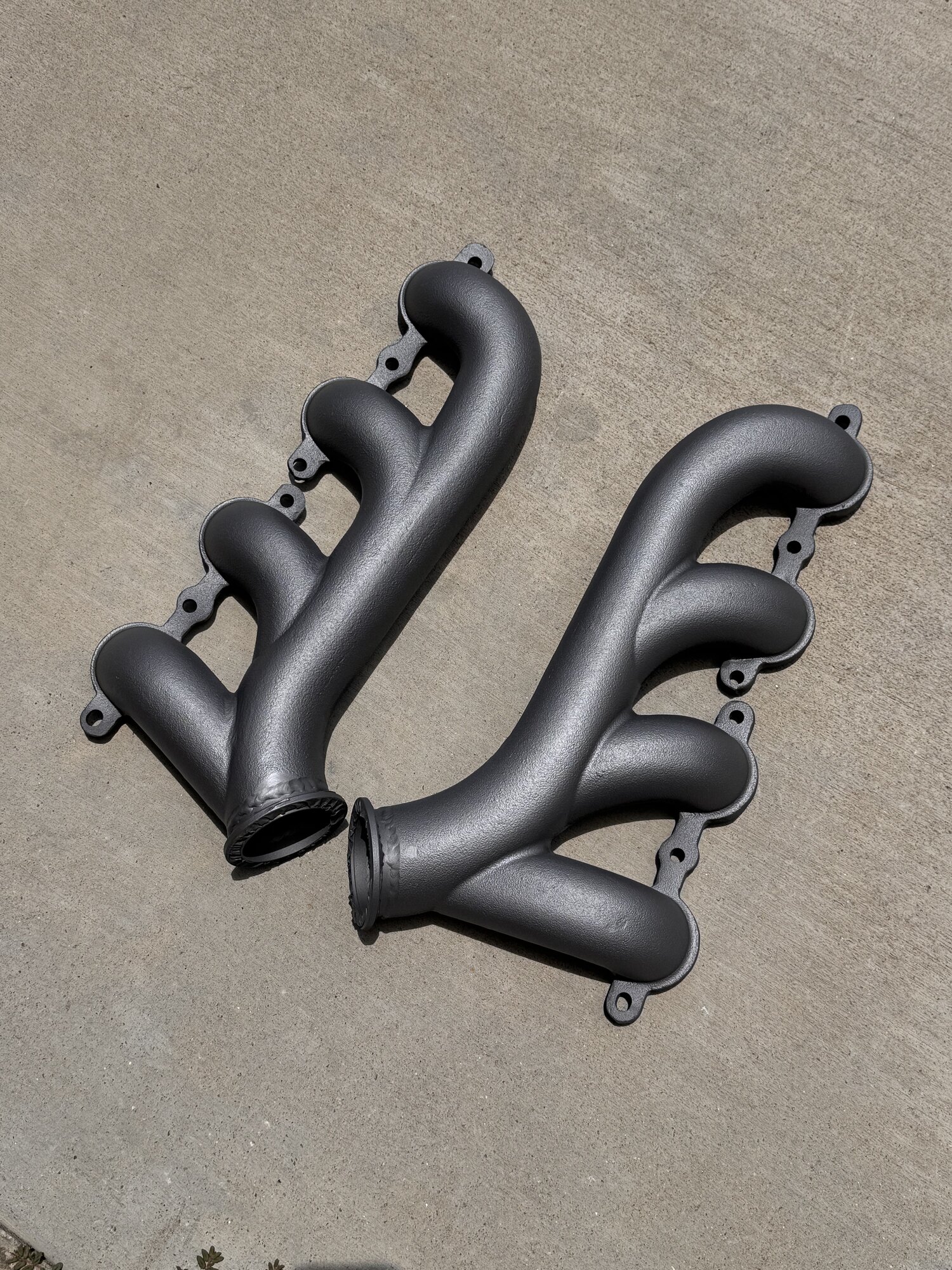 Cast iron manifolds after V-band flanges were TIG welded on, baked, blasted and sprayed with Zybar high temp coating
