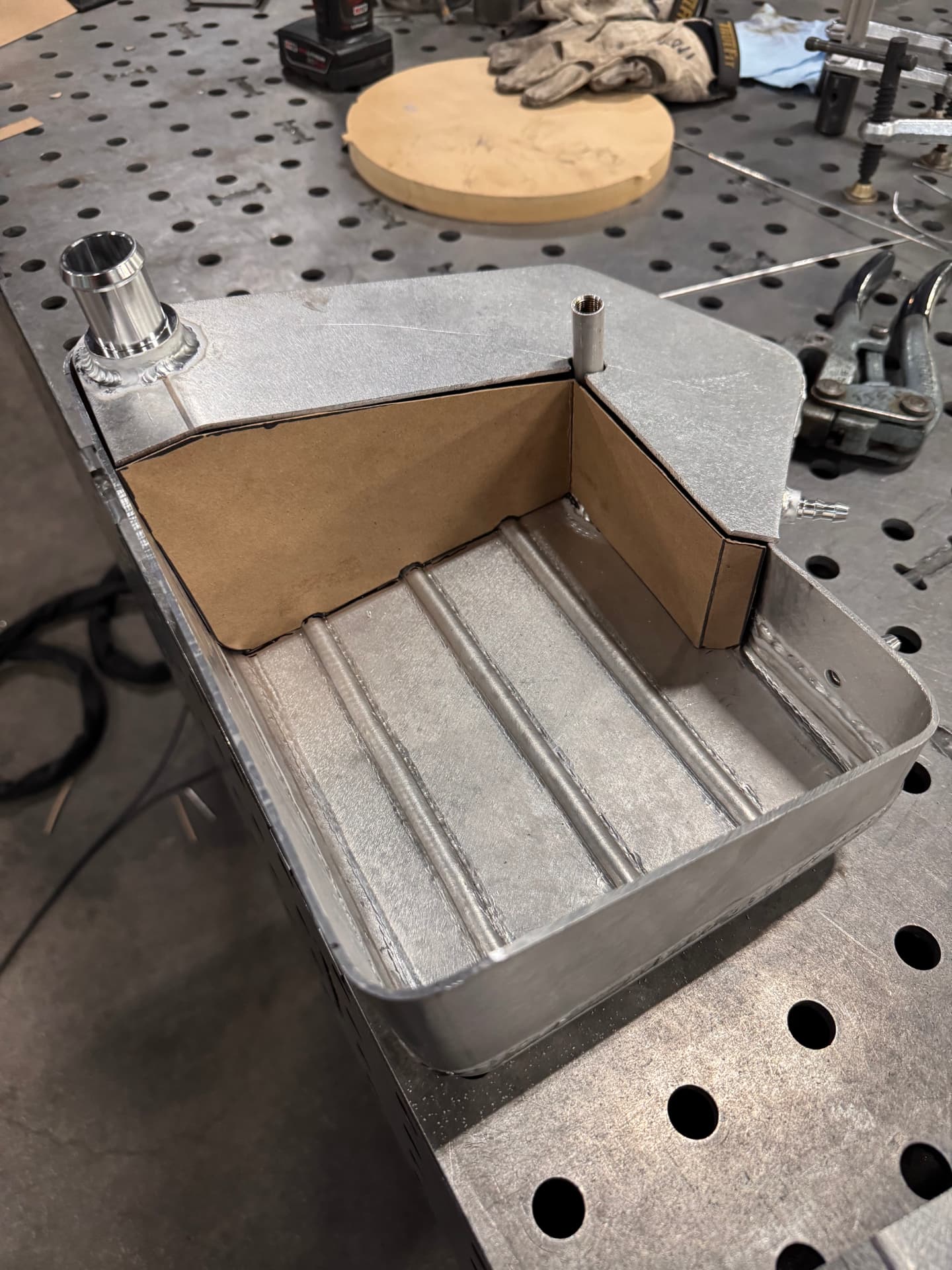 Tank shell in progress — internal baffle mocked up in cardboard before the top panel goes on.