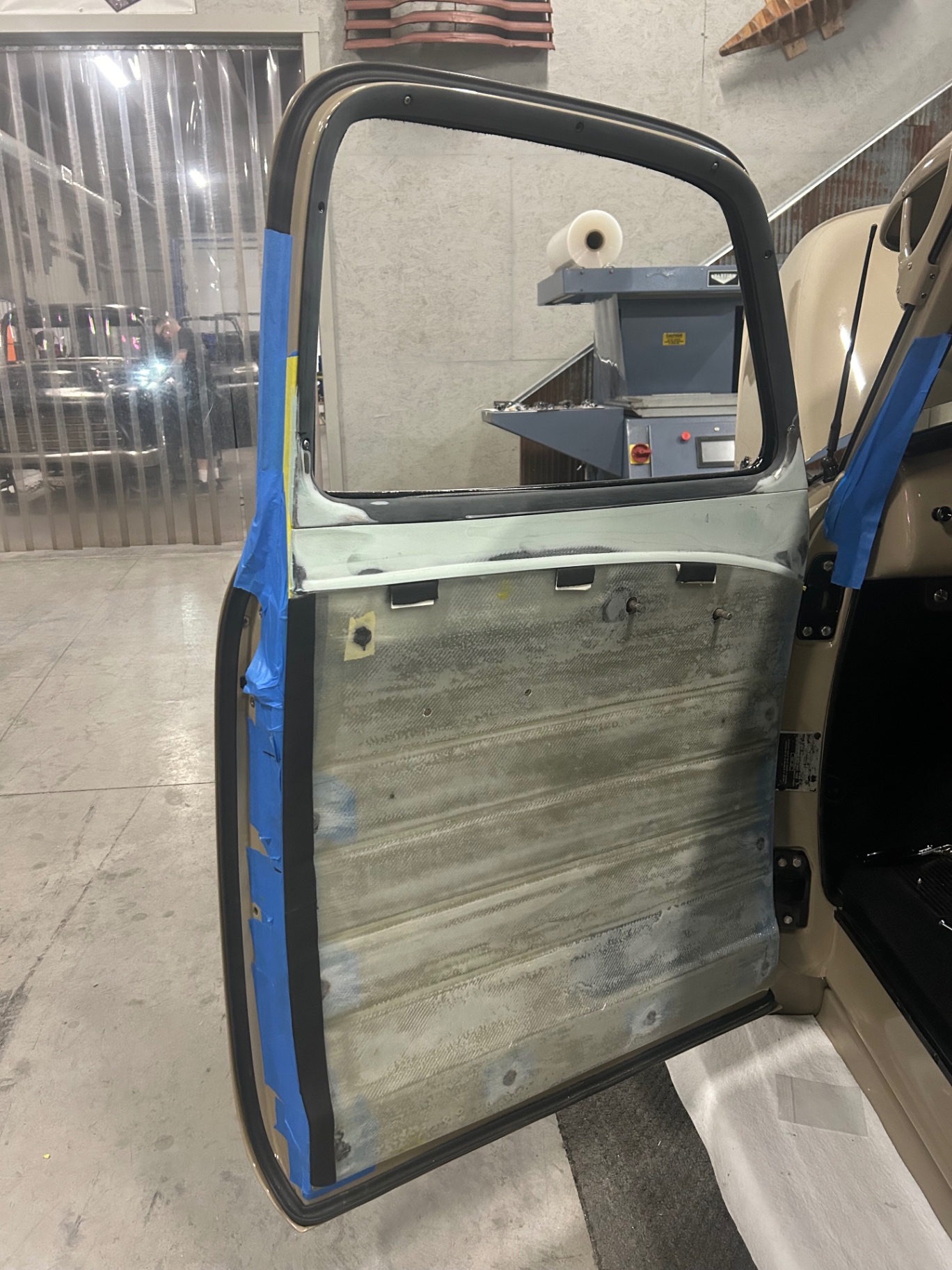 Bare door shell in the shop — starting point before fabricating the new metal upper.