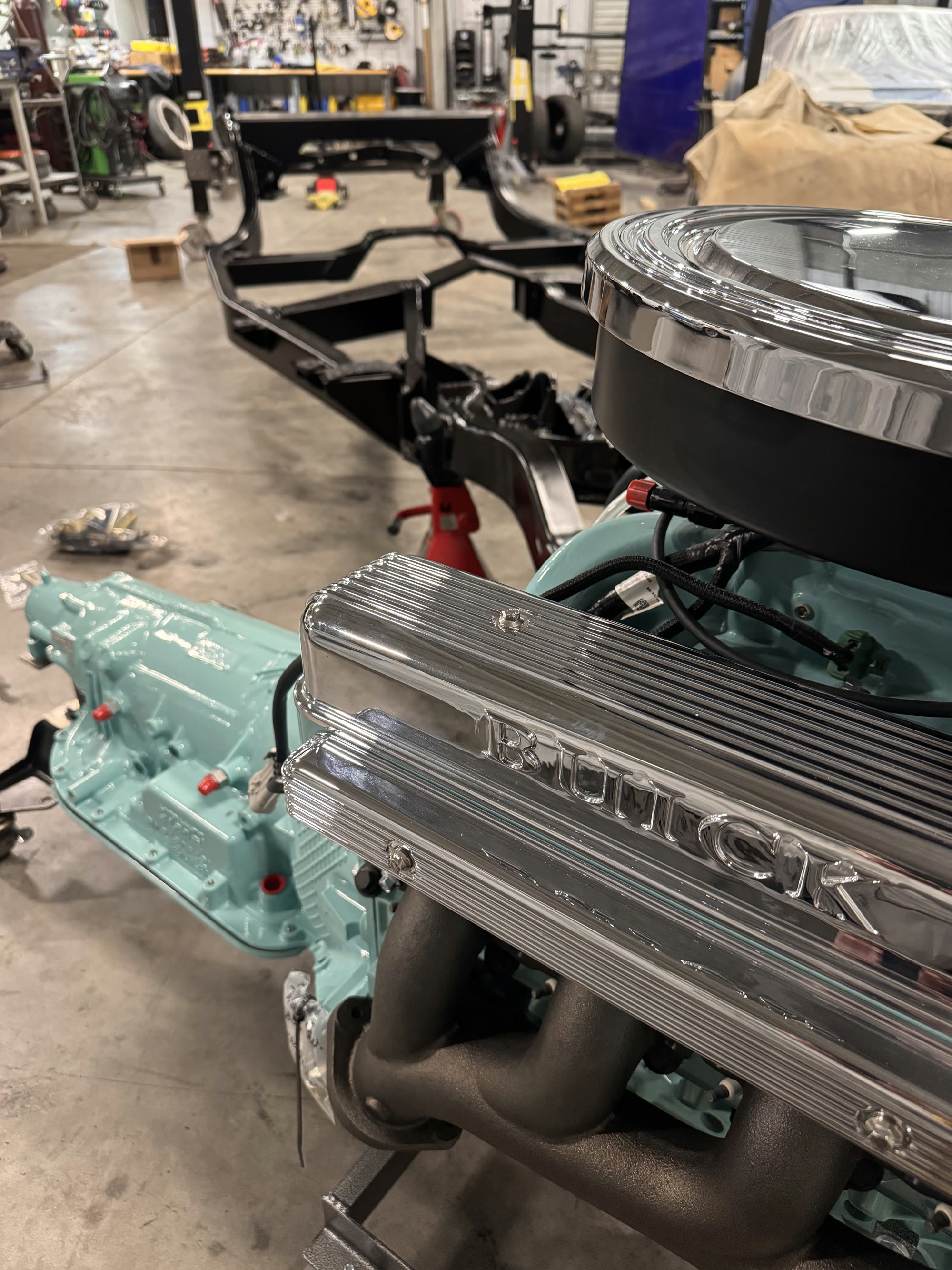 Polished finned Buick valve covers and the 4L80E on the floor alongside
