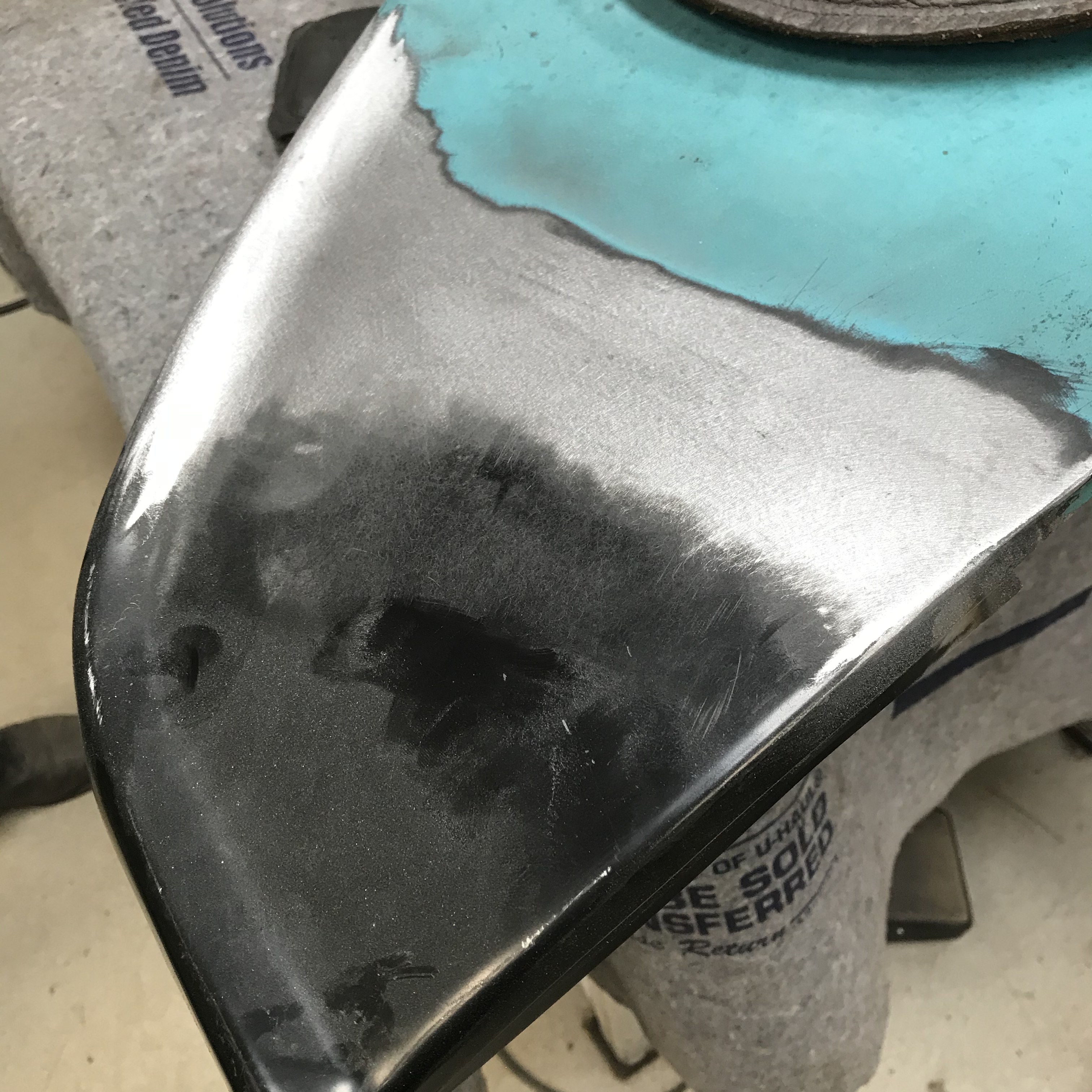 Bare-metal bodywork on a corner panel — worked straight by hand, with zero filler used anywhere on the truck.