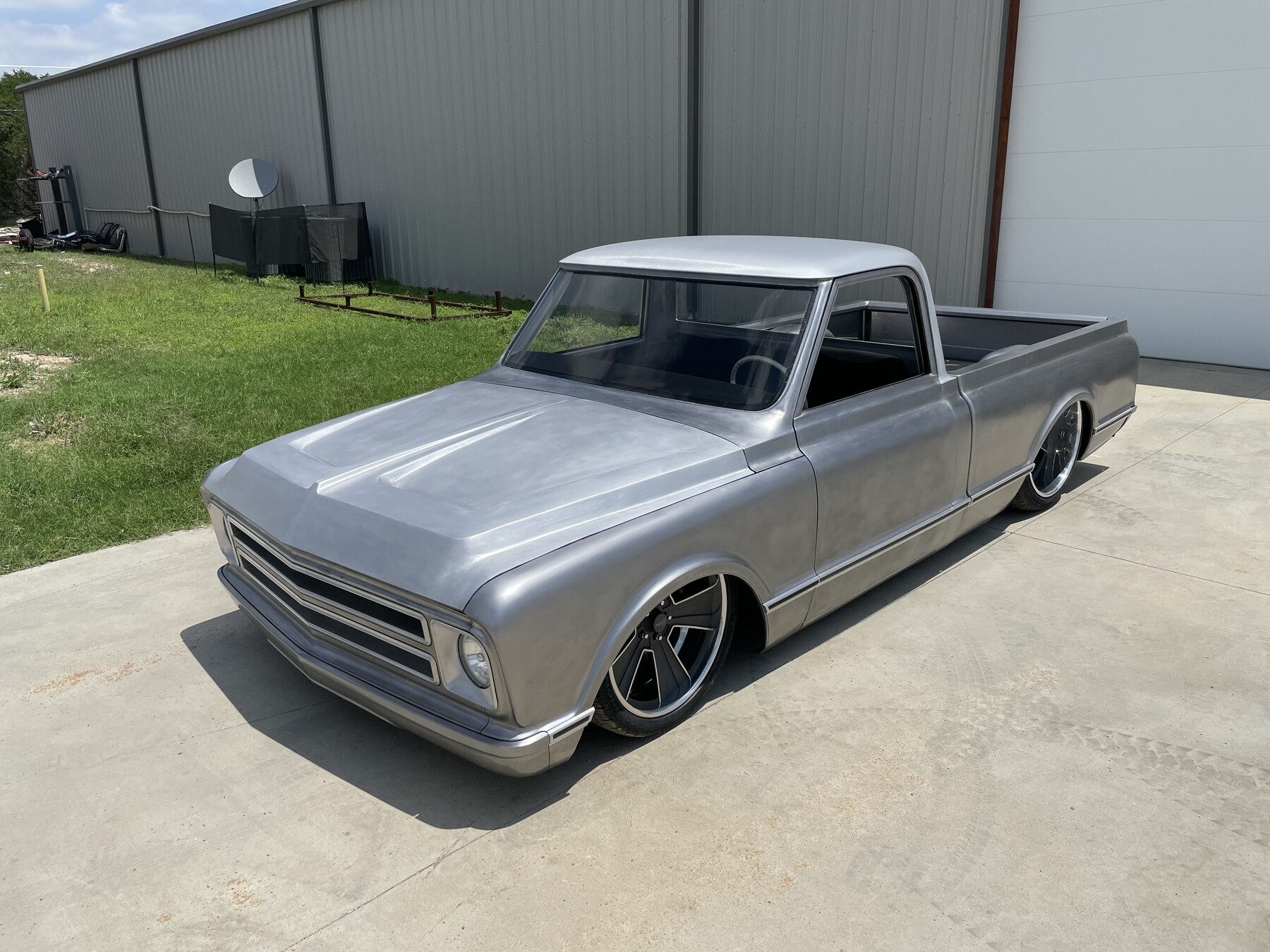 Bare metal in the sun — wedge chopped top, aluminum hood, and scratch-built bed.
