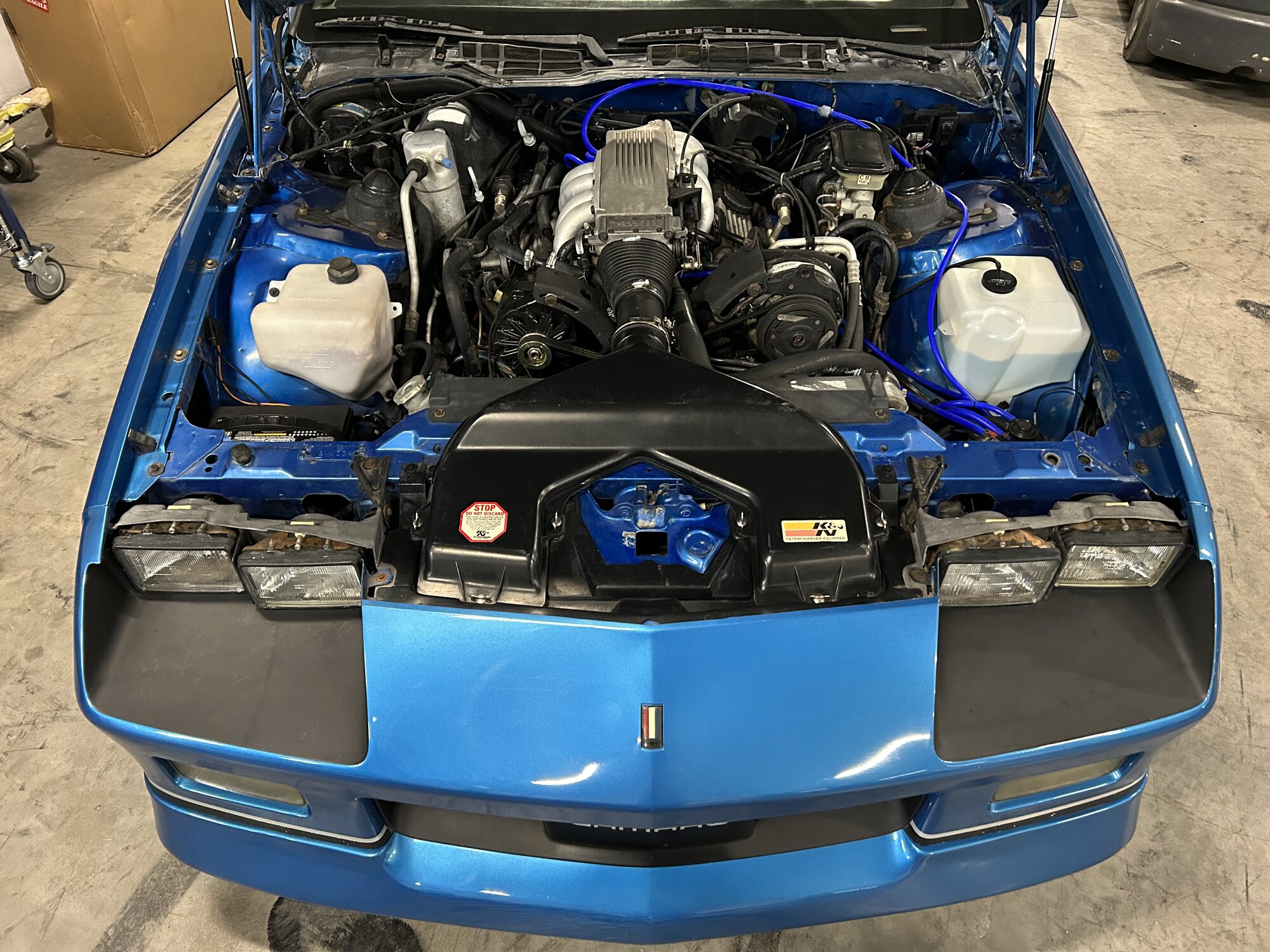 Hood up for the first inspection — Tuned Port 305 with the factory airbox still in place.