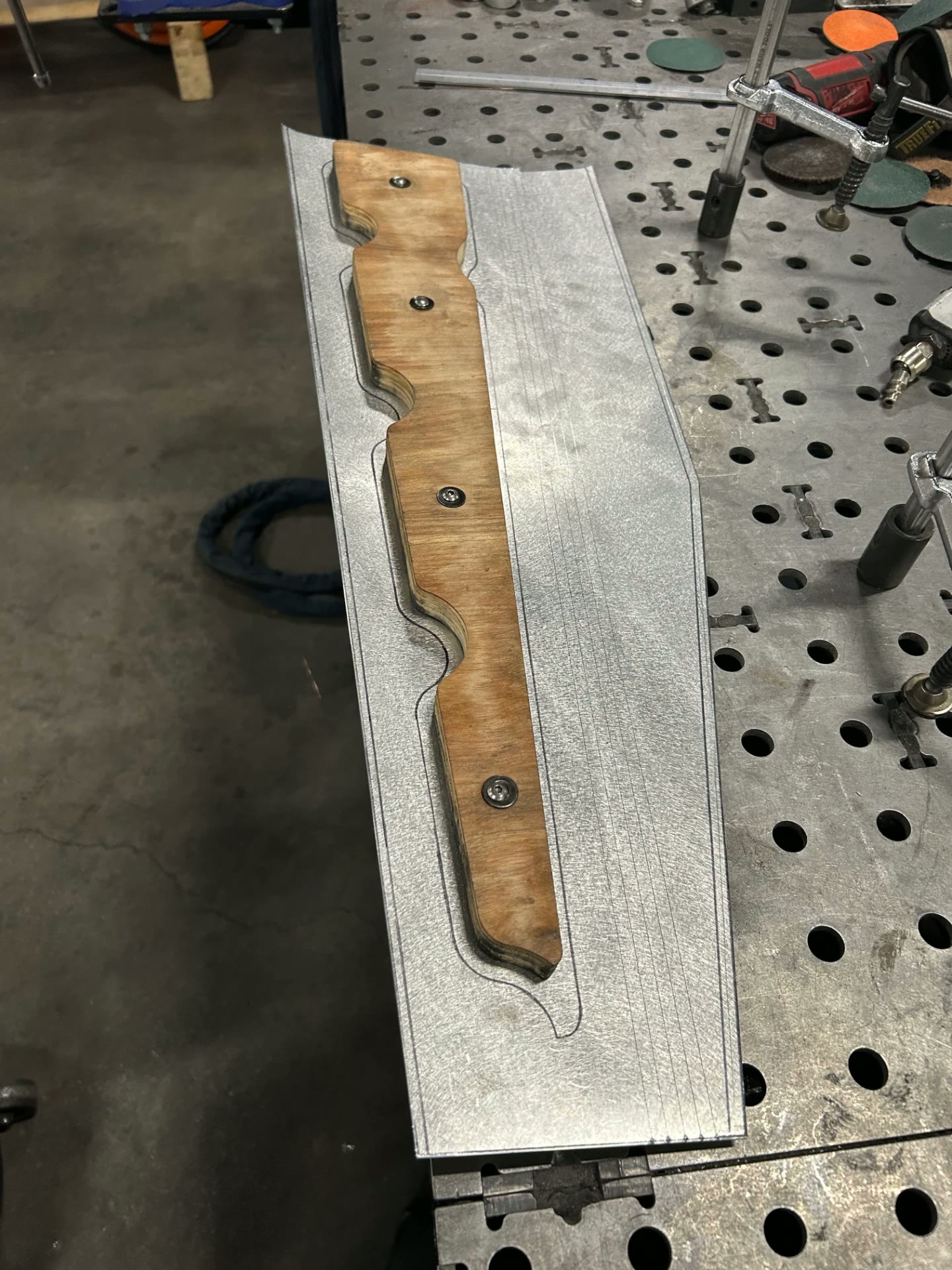 Form clamped to the aluminum blank before forming.