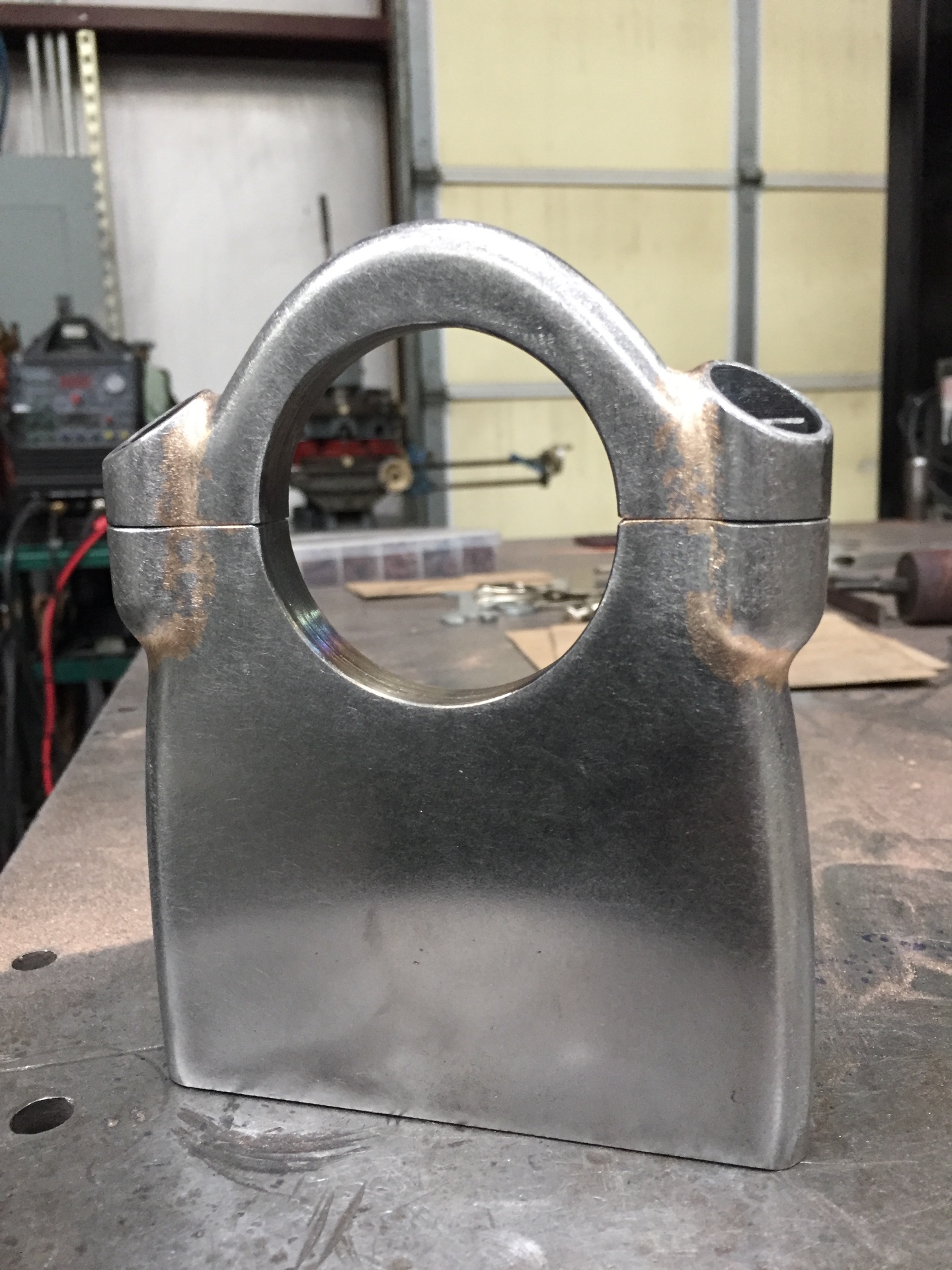 Finished column drop — split clamp with a pinch bolt, shaped body, clean welds.