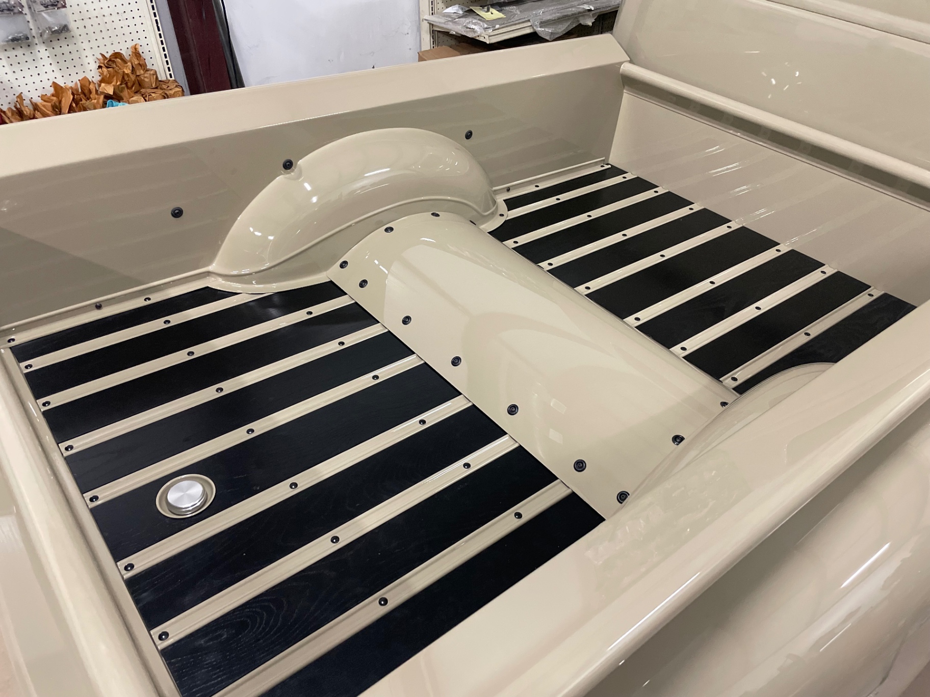 Bed floor assembled — black wood planks between painted strips, wheel tub back in.