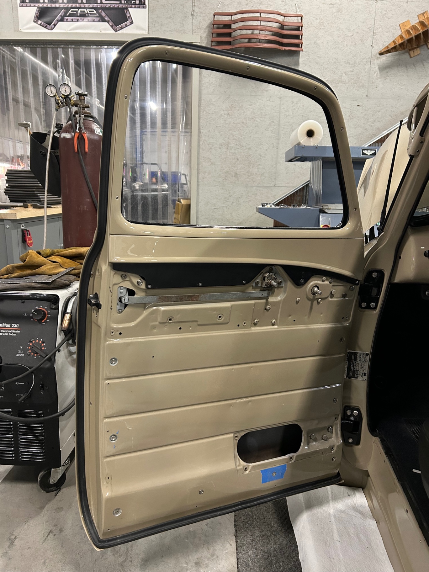 Inner door structure exposed — window regulator and mounts, ready for the fabricated panel.