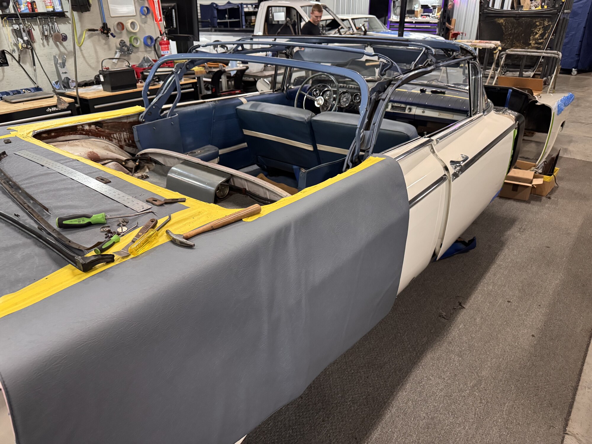 Old top off — bows cleaned of grime and glue, every pivot point lubed before the new canvas goes on
