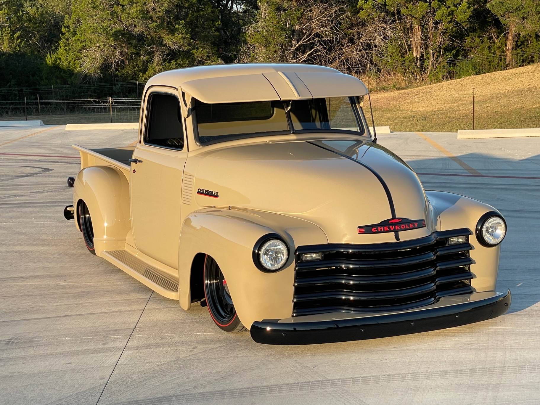 Golden-hour front three-quarter — every panel reading clean.