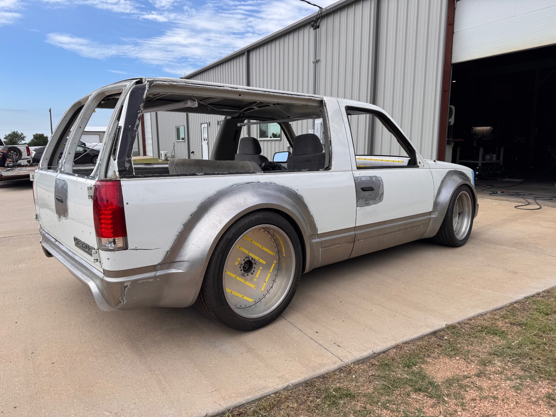 Passenger side three-quarter — full wide-body proportions on roller wheels.