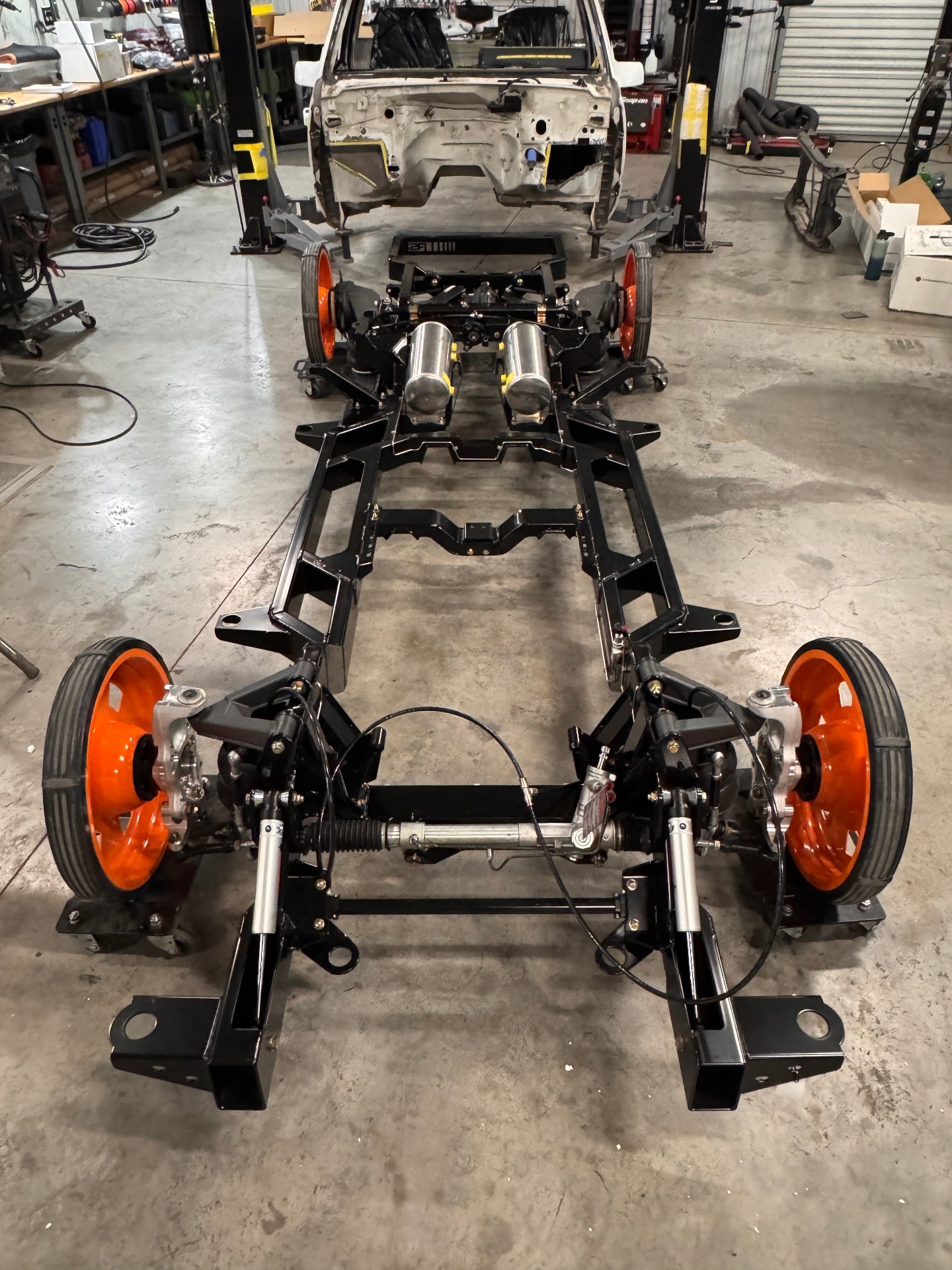 Full overhead view — suspension front to rear, rolling on the shop setup wheels.