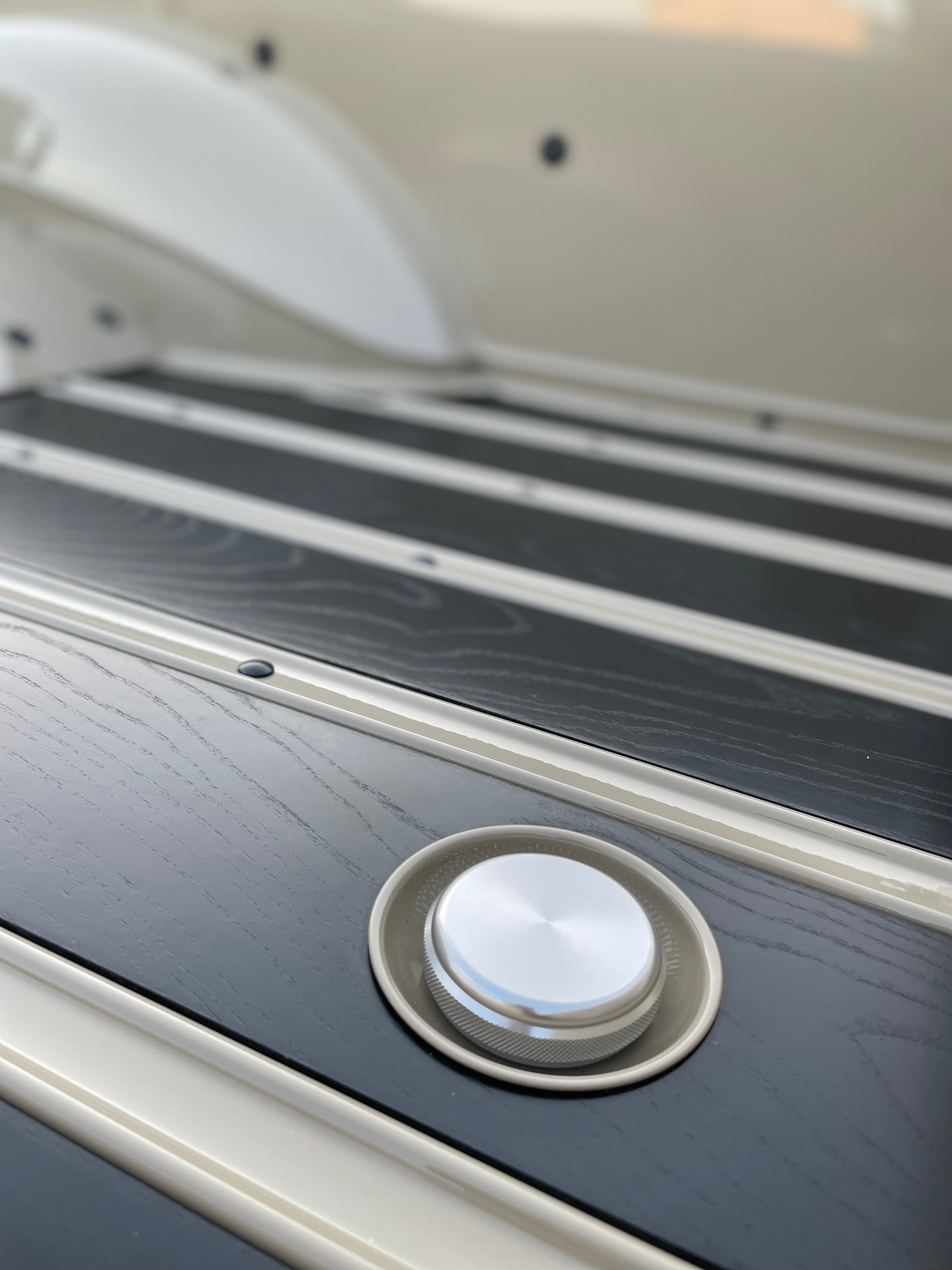 Bed floor detail — polished billet fuel filler flush with the black wood plank.