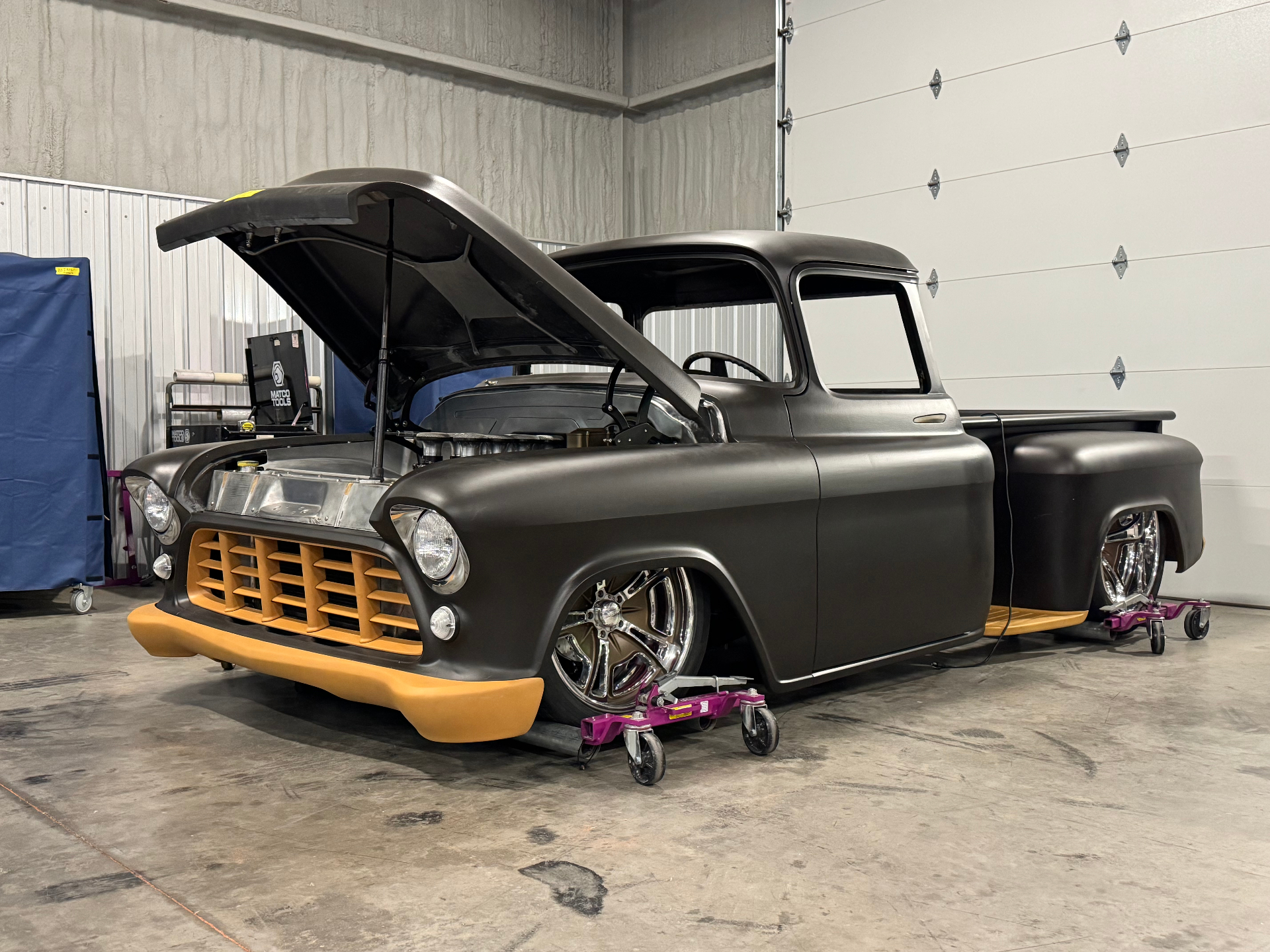 Primer body with bronze grille, bumper, and forged wheels test-fit.