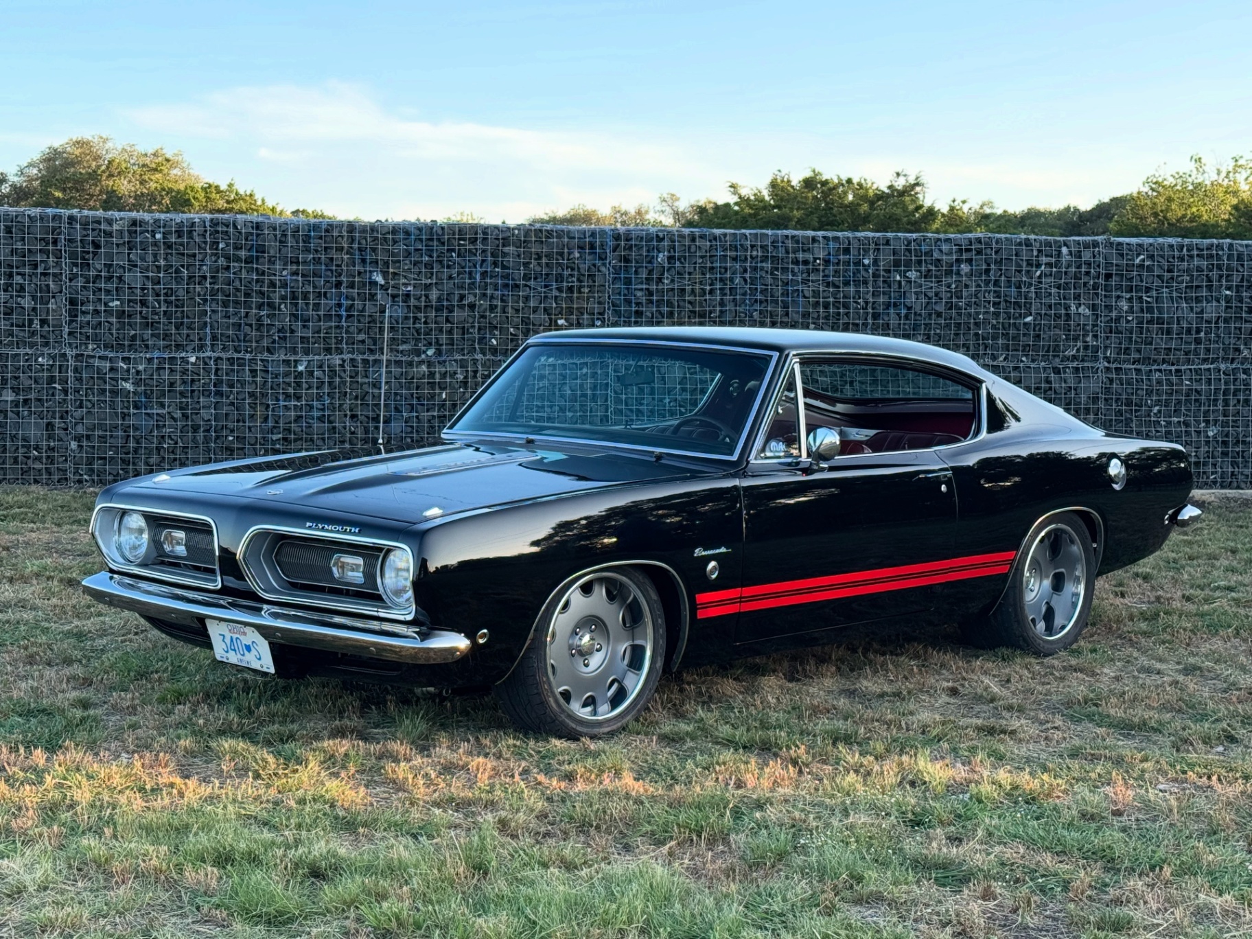 Black Plymouth Barracuda fastback with red stripes