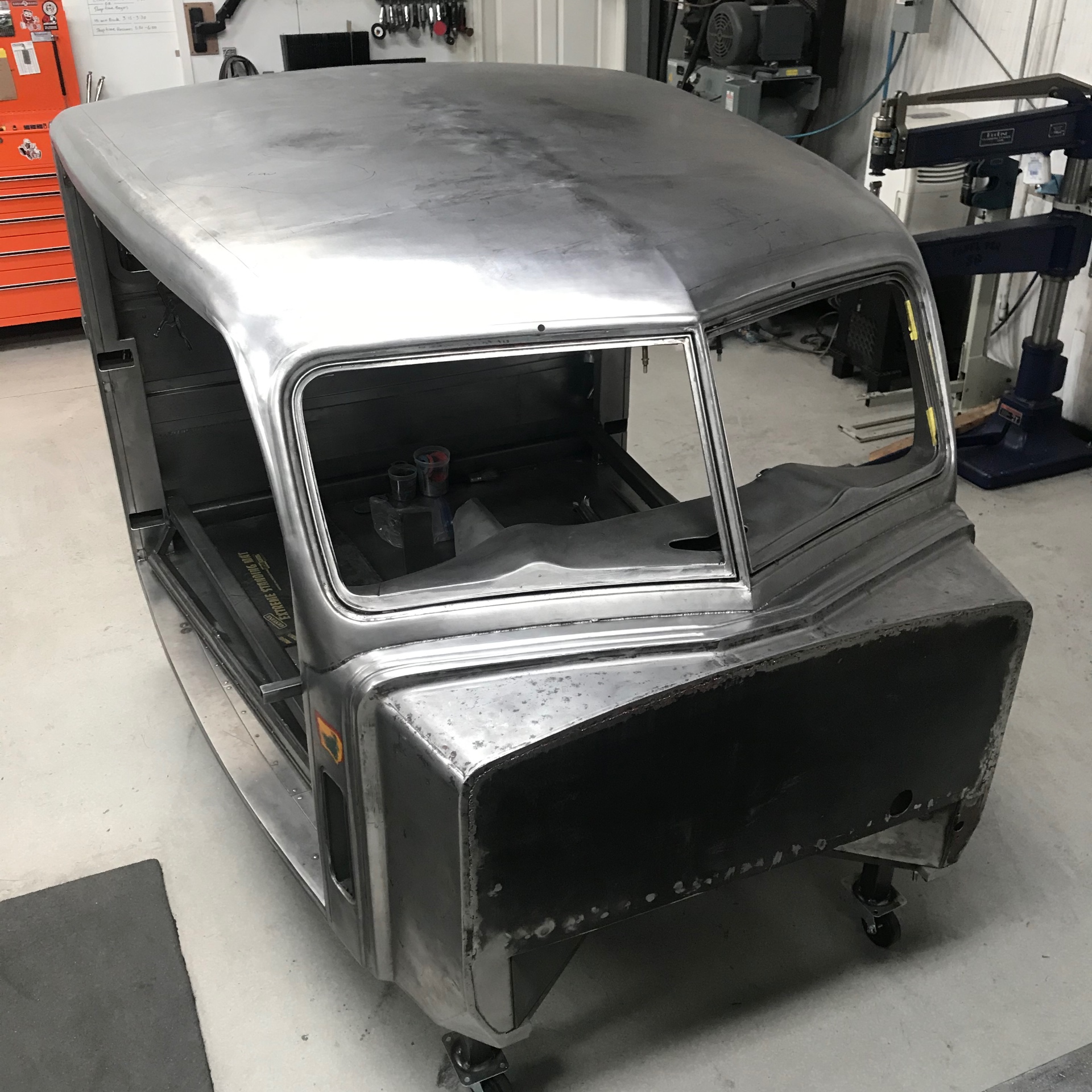 Passenger side after final planishing — one continuous skin from cowl to back panel.