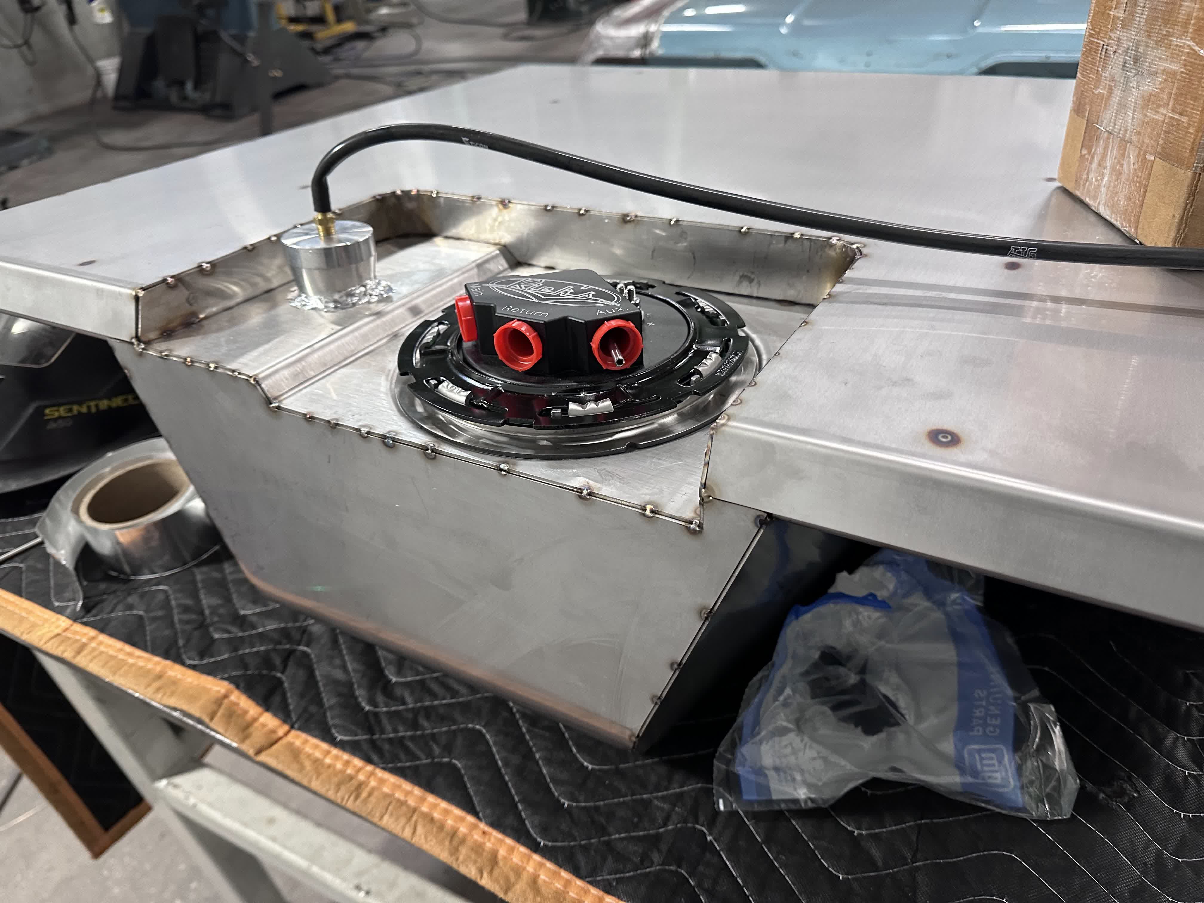 Rick's Tanks EFI hat and vent bung dropped into the recessed pocket before final welding.