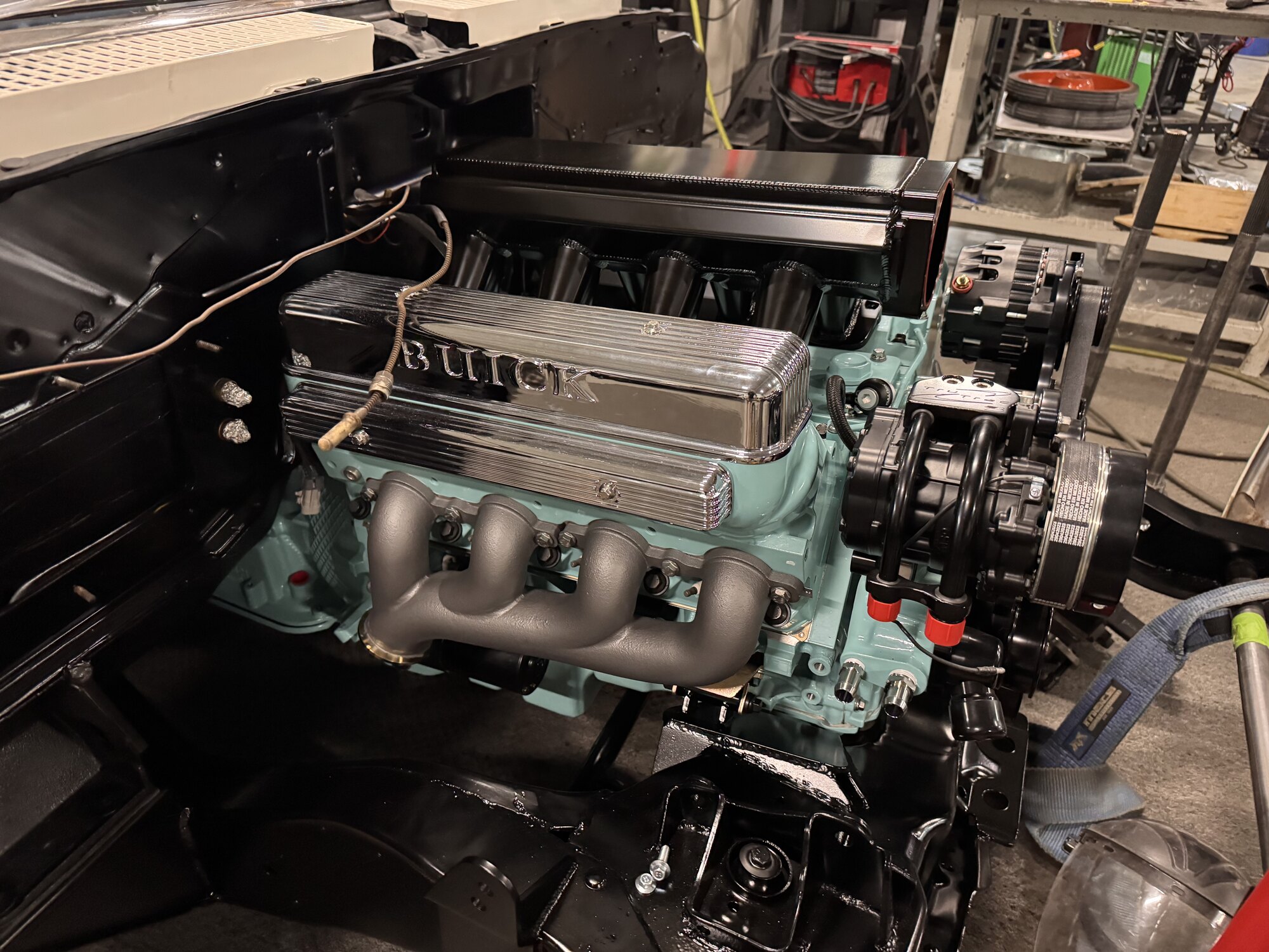 Passenger side in the chassis — coated manifold, chrome covers and the new sheet metal intake mocked up
